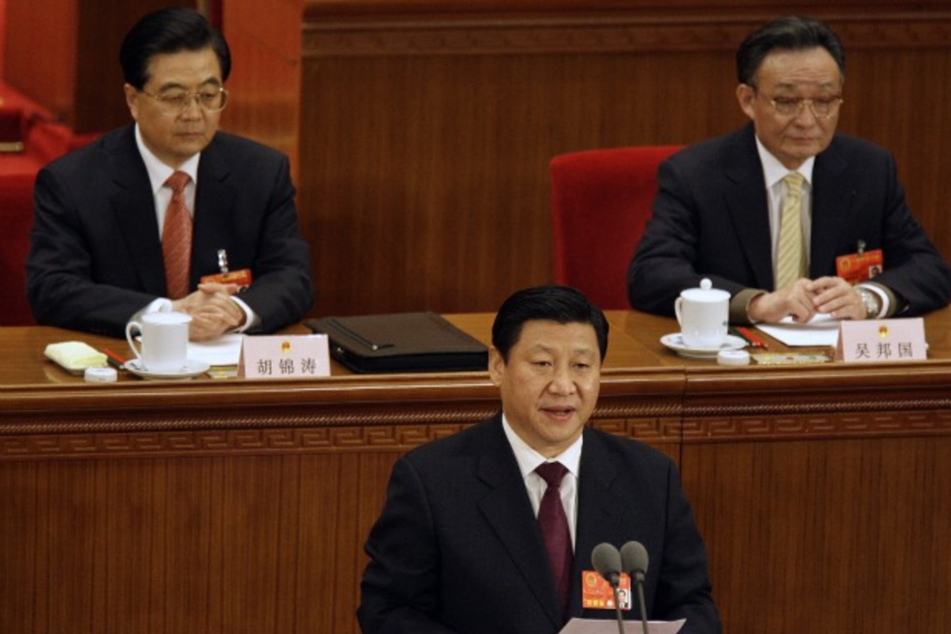 <p>Current Vice President Xi Jinping reads a statement as President Hu Jintao (L) and parliament chief Wu Bangguo listen during the 11th National People’s Congress in Beijing on March 11, 2008.</p>
