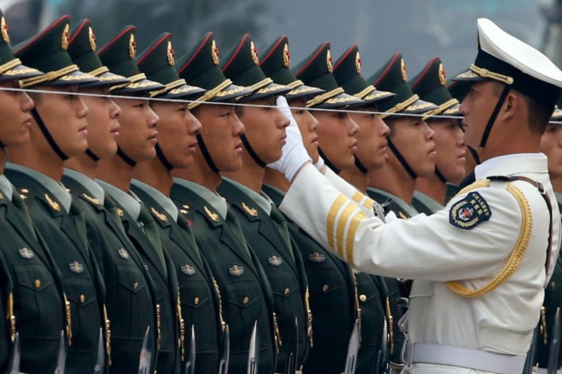 <p>An officer of the Chinese People’s Liberation Army (PLA) uses a string to ensure that the soldiers making up a guard of honour…resident Hamid Karzai outside the Great Hall of the People in Beijing on September 27, 2013. (Kim Kyung-Hoon/Courtesy Reuters)</p>
