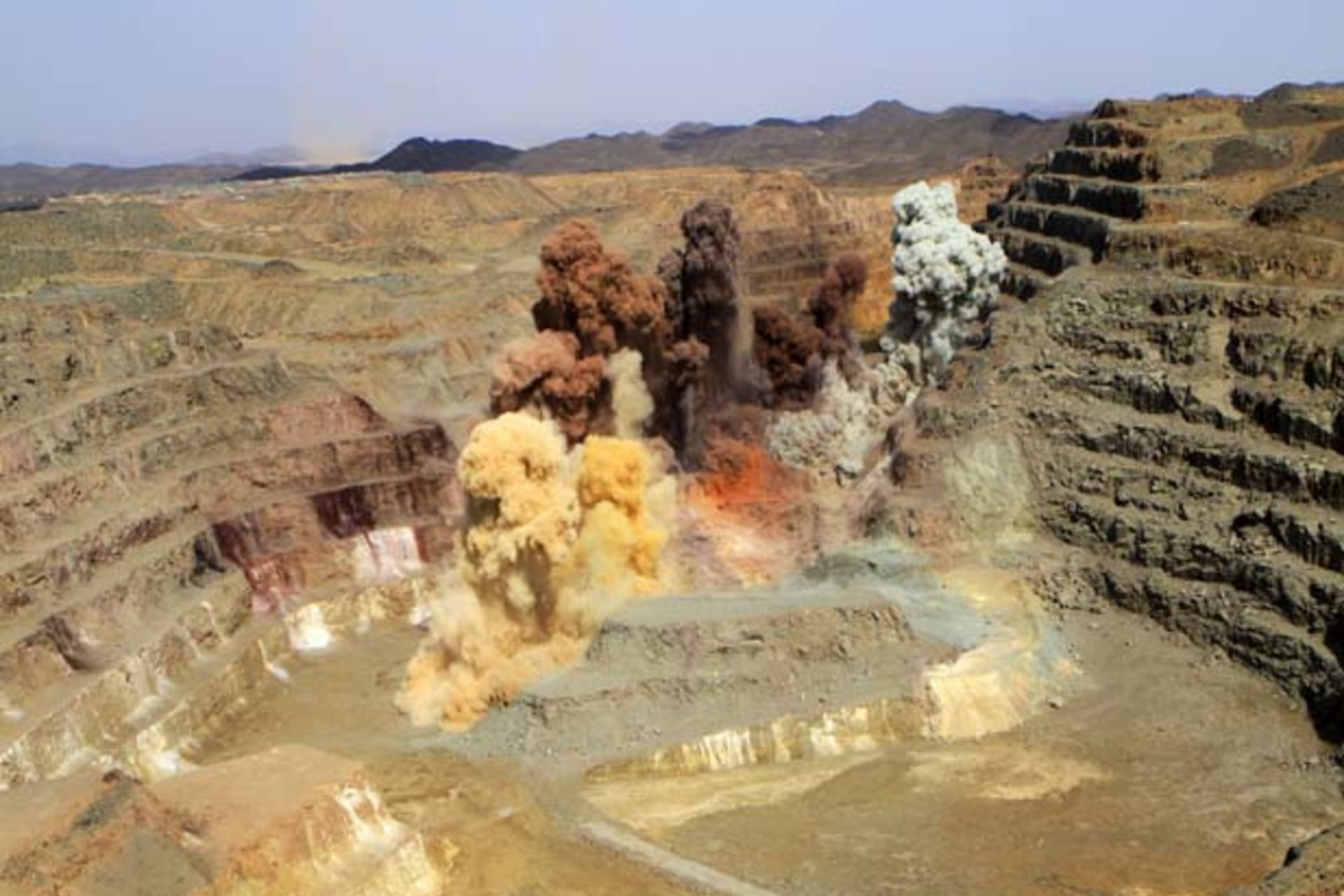 Smoke rises after a blast in a quarry at the Ariab mine