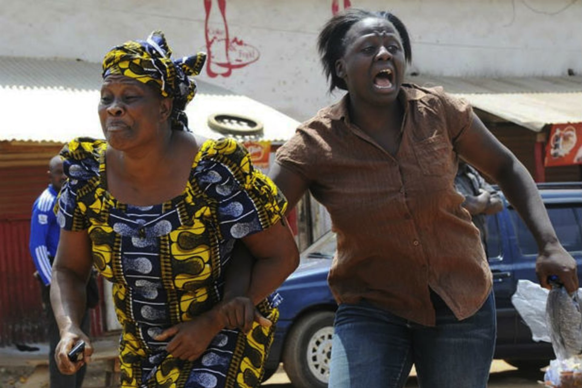 Women run from the scene of a church bombing in Nigeria 11/03/2012