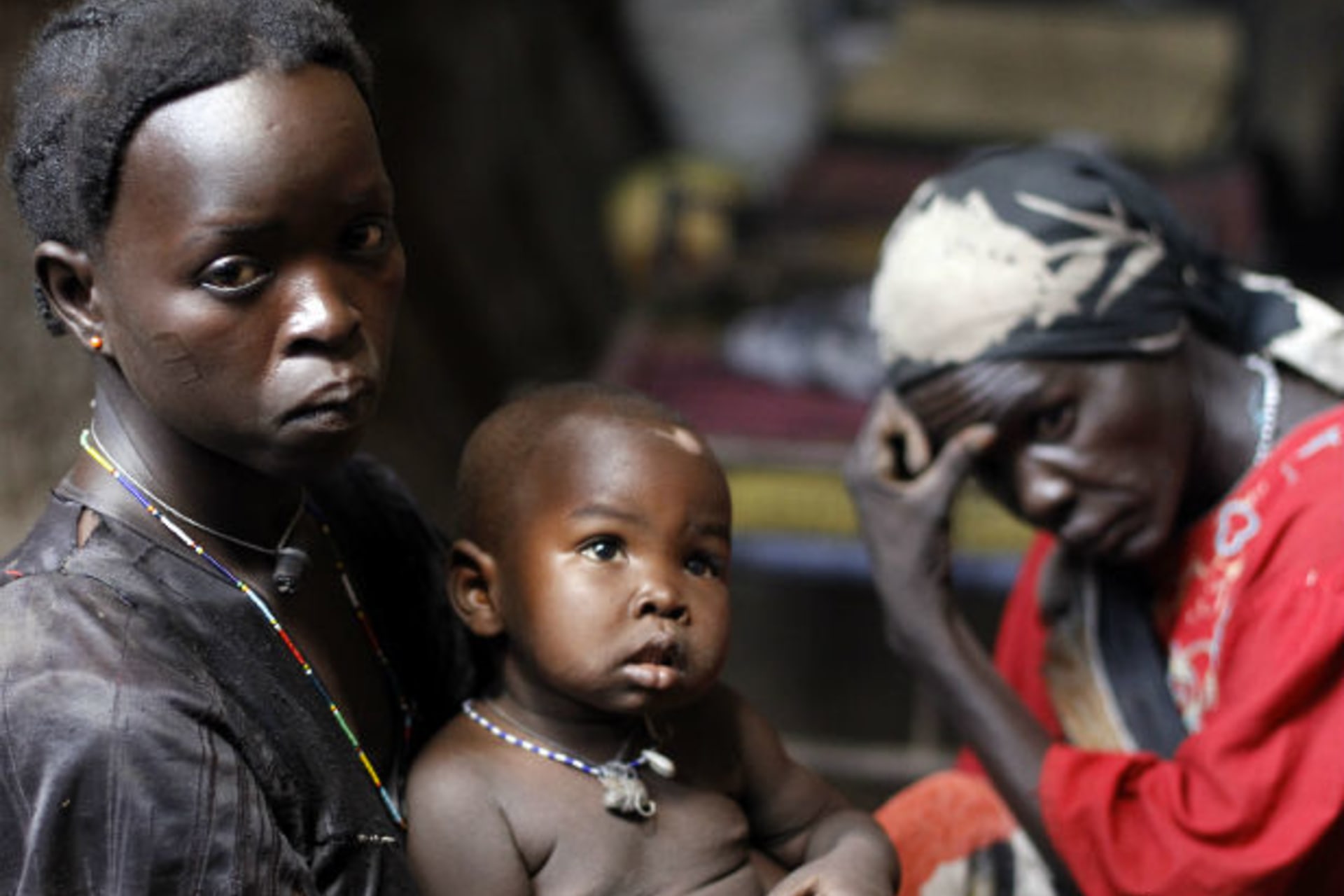 A woman holds her child in a cave in Bram village in the Nuba Mountains, South Kordofan, April 28, 2012.