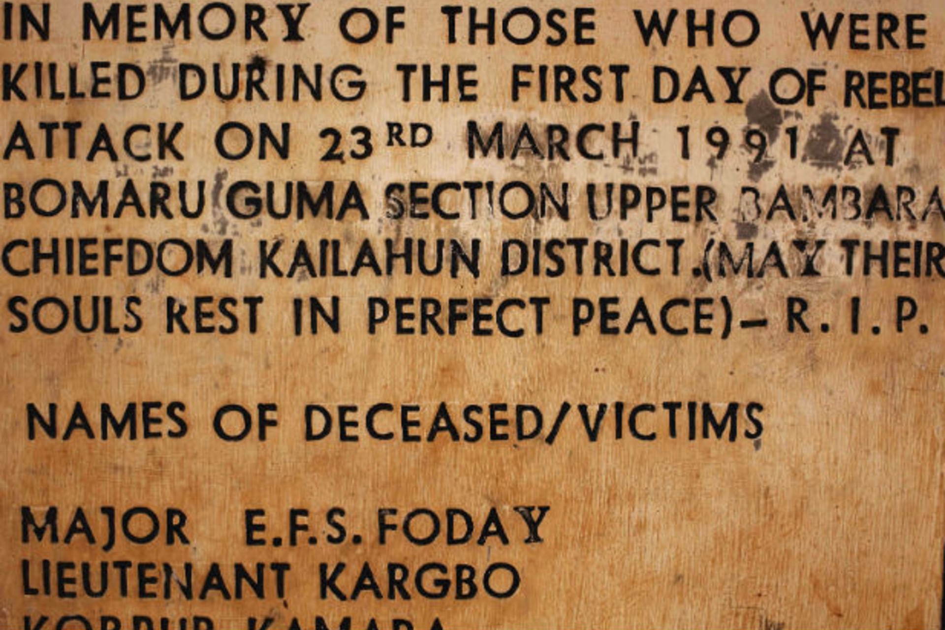 A sign commemorating the start of the civil war is displayed at a memorial site where the conflict began, in the village of Bomaru, eastern Sierra Leone April 22, 2012.