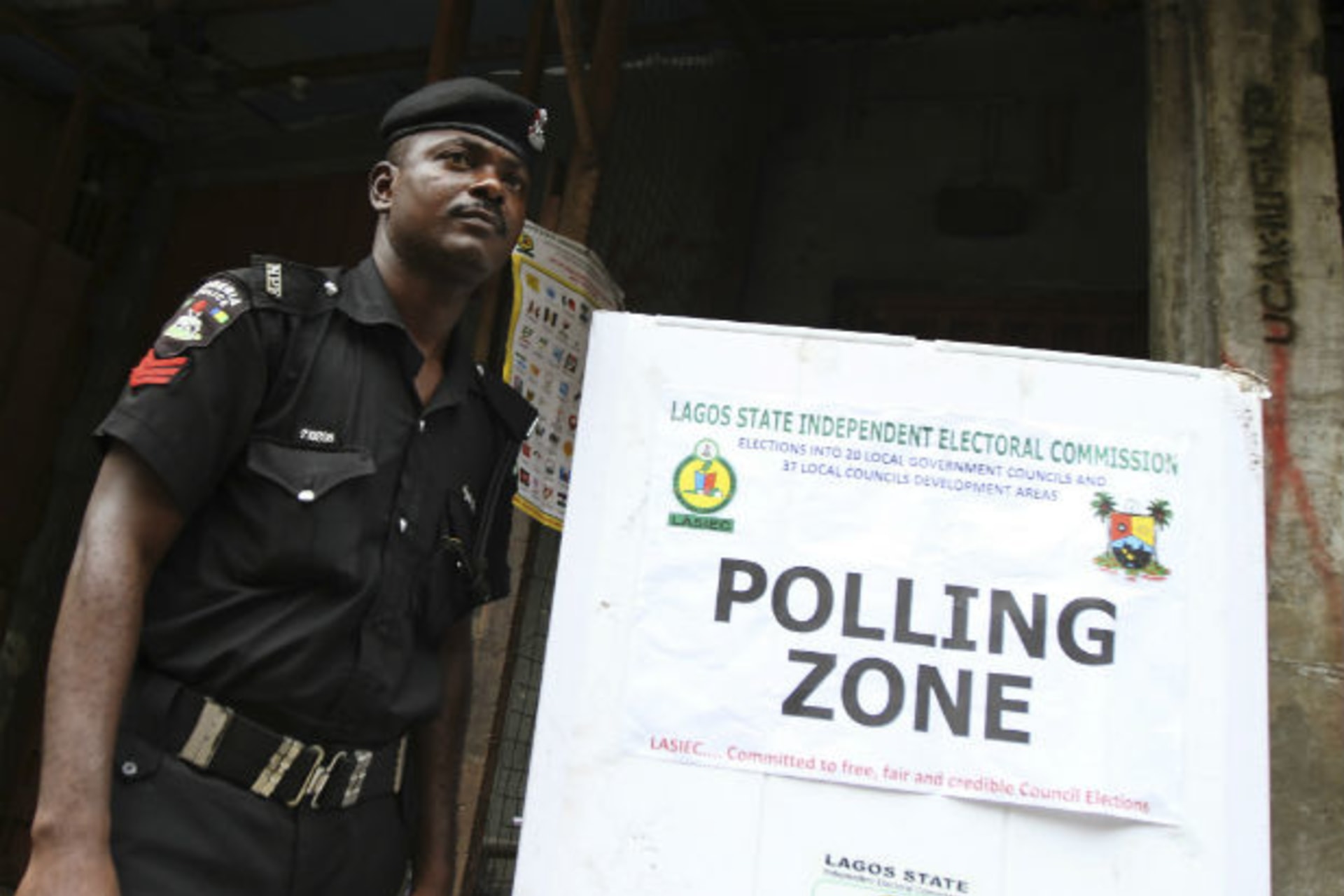 A policeman stands near a polling booth during the local government election in Nigeria's commercial capital Lagos October 22, 2011.