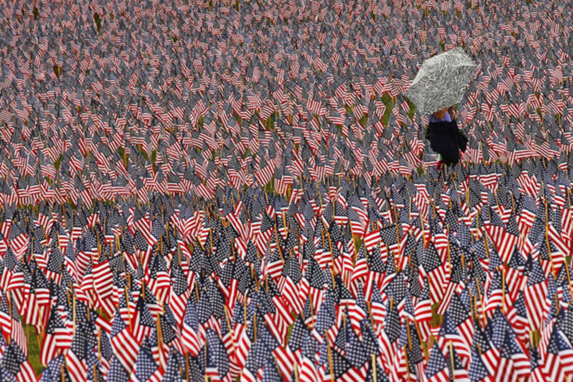 <p>A pedestrian walks through a Memorial Day display of American flags on the Boston Common (Brian Snyder/Courtesy Reuters).</p>
