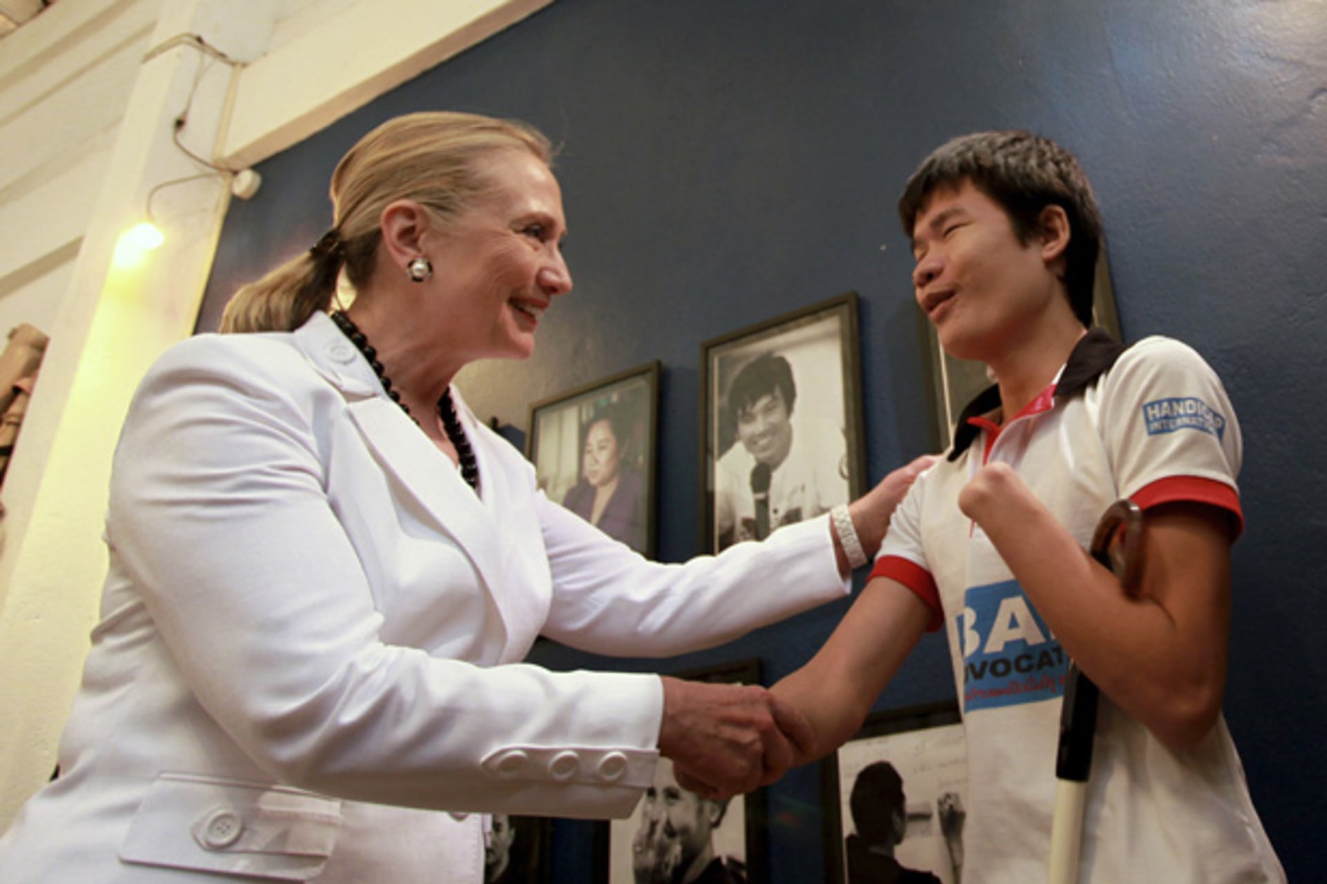 <p>U.S. Secretary of State Clinton talks to a disabled boy at the Cooperative Orthotic and Prosthetic Enterprise visitor center in Vientiane.</p>
