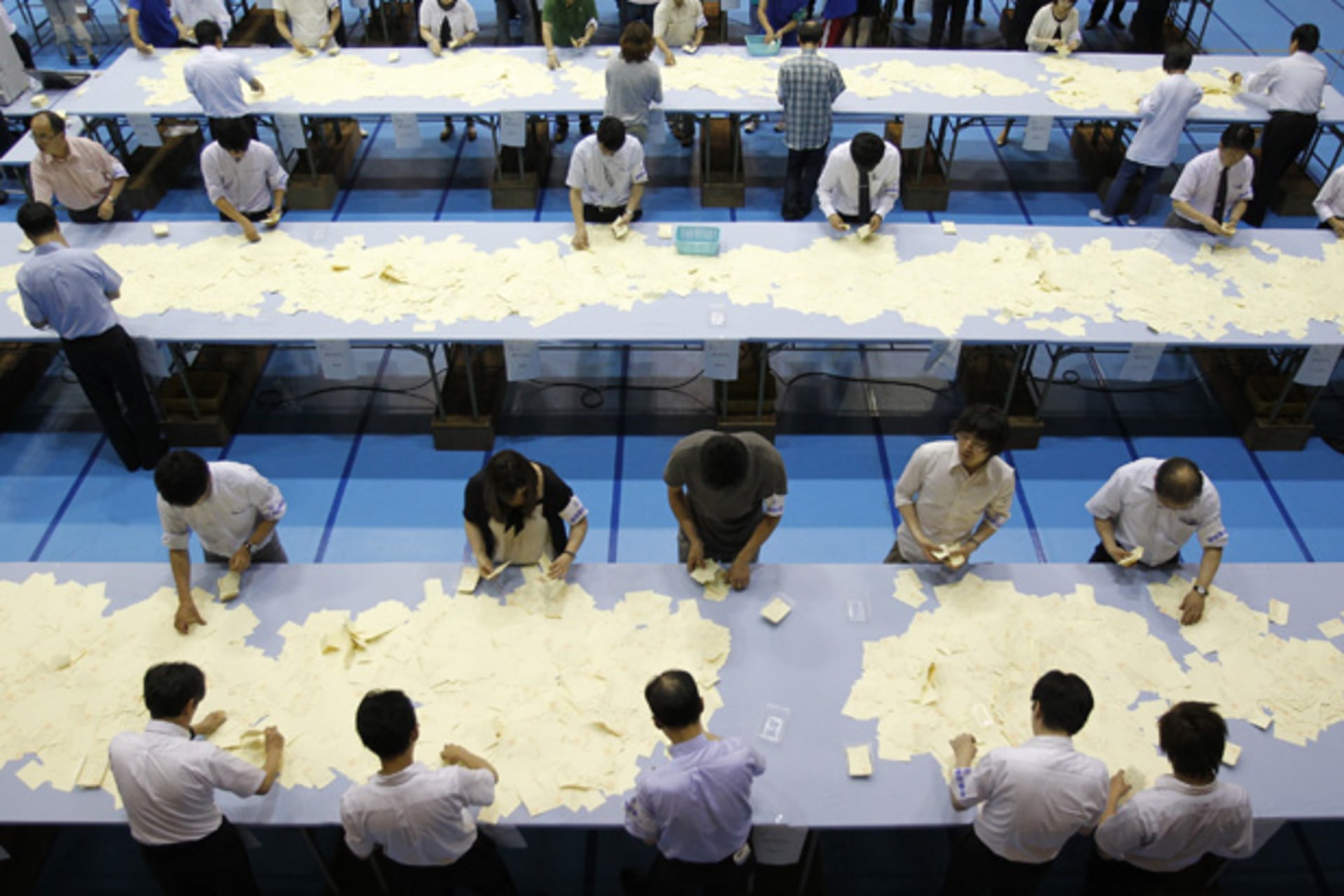 <p>Election officers count votes at a ballot counting center for the upper house election in Tokyo July 11, 2010.</p>
