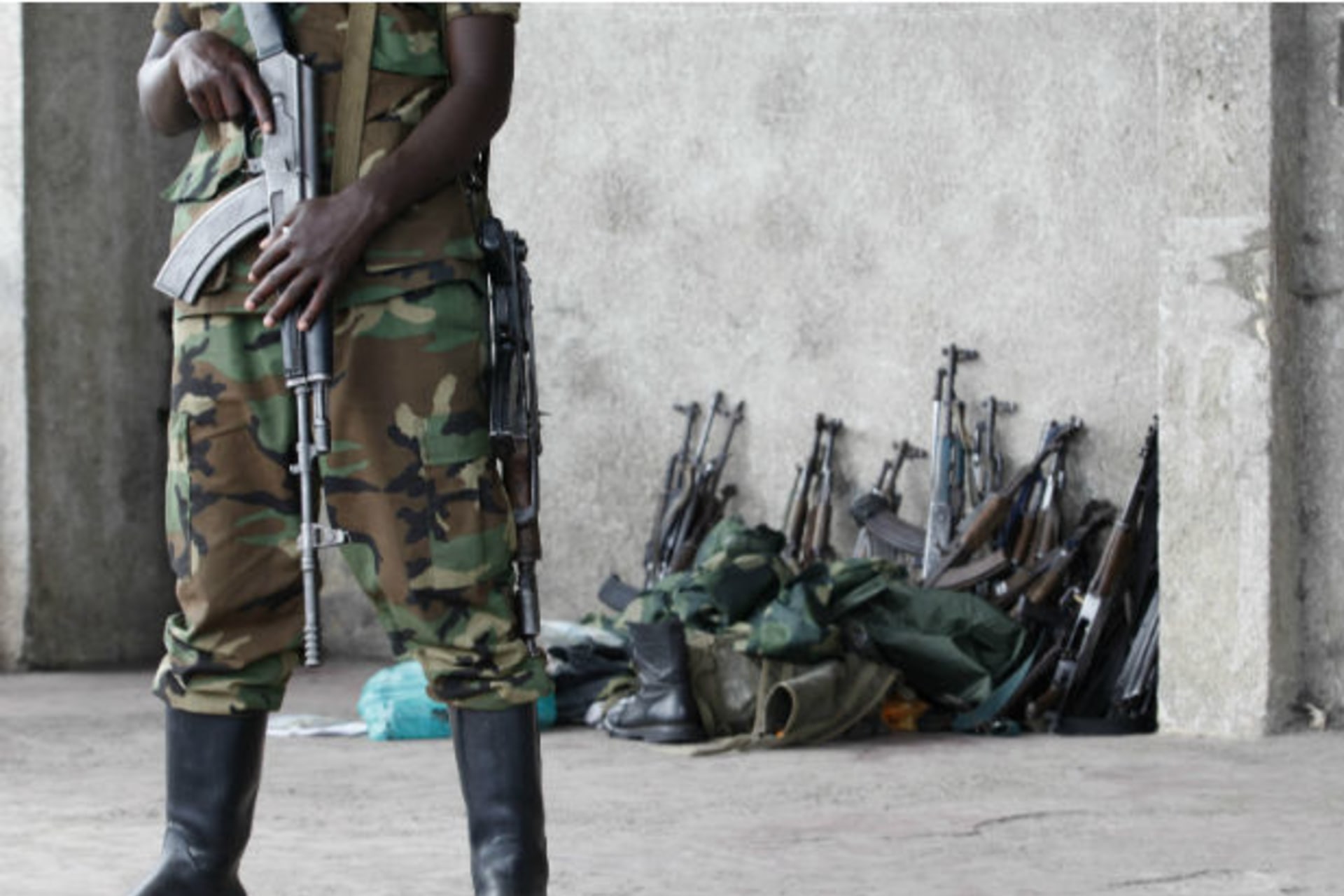 M23:  A M23 rebel guards weapons returned by the government's army in Goma city November 21, 2012.