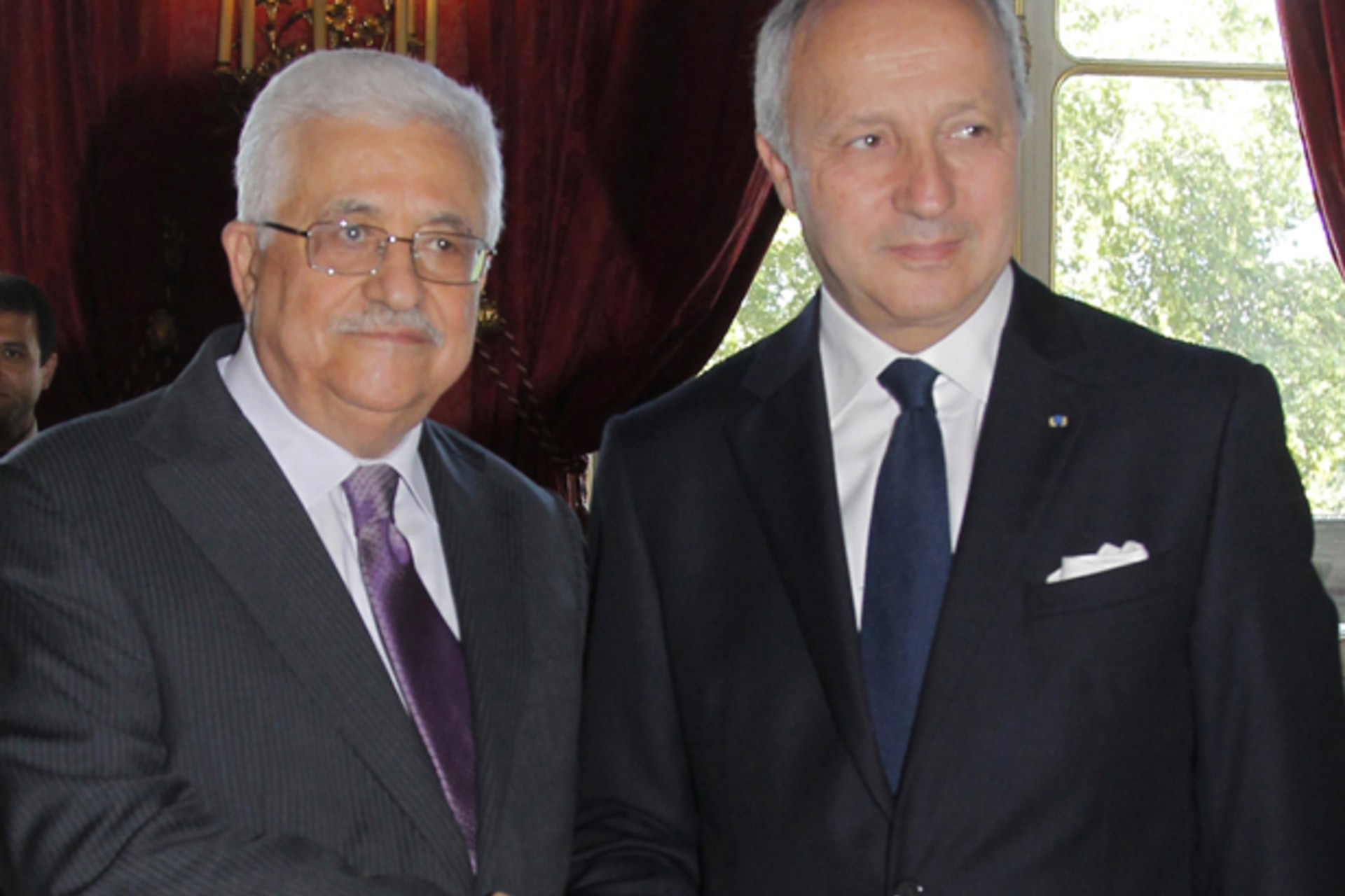 France's Foreign Affairs Minister Fabius greets Palestinian President Mahmoud Abbas  before a meeting in Paris