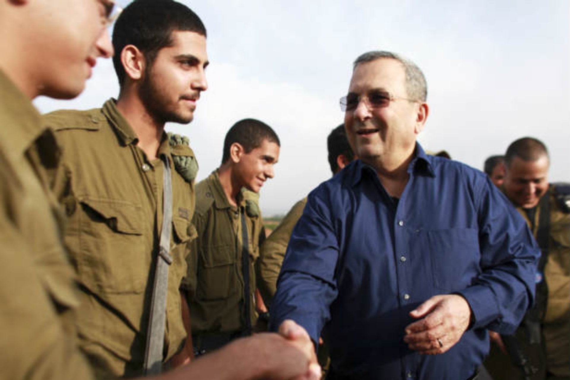 Israel's defence minister Barak shakes hands with a soldier during a news conference near Tel Aviv on November 18, 2012 (Bar-On/Courtesy Reuters).