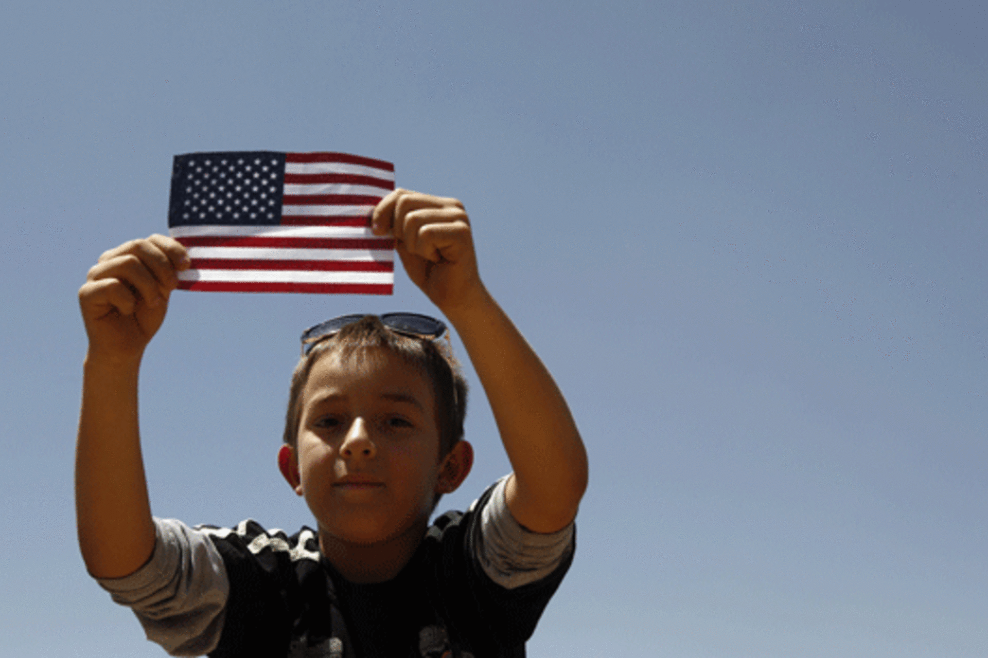 <p>A boy listens to U.S. President Barack Obama speak on immigration reform at Chamizal National Memorial Park in El Paso, Texas.</p>
