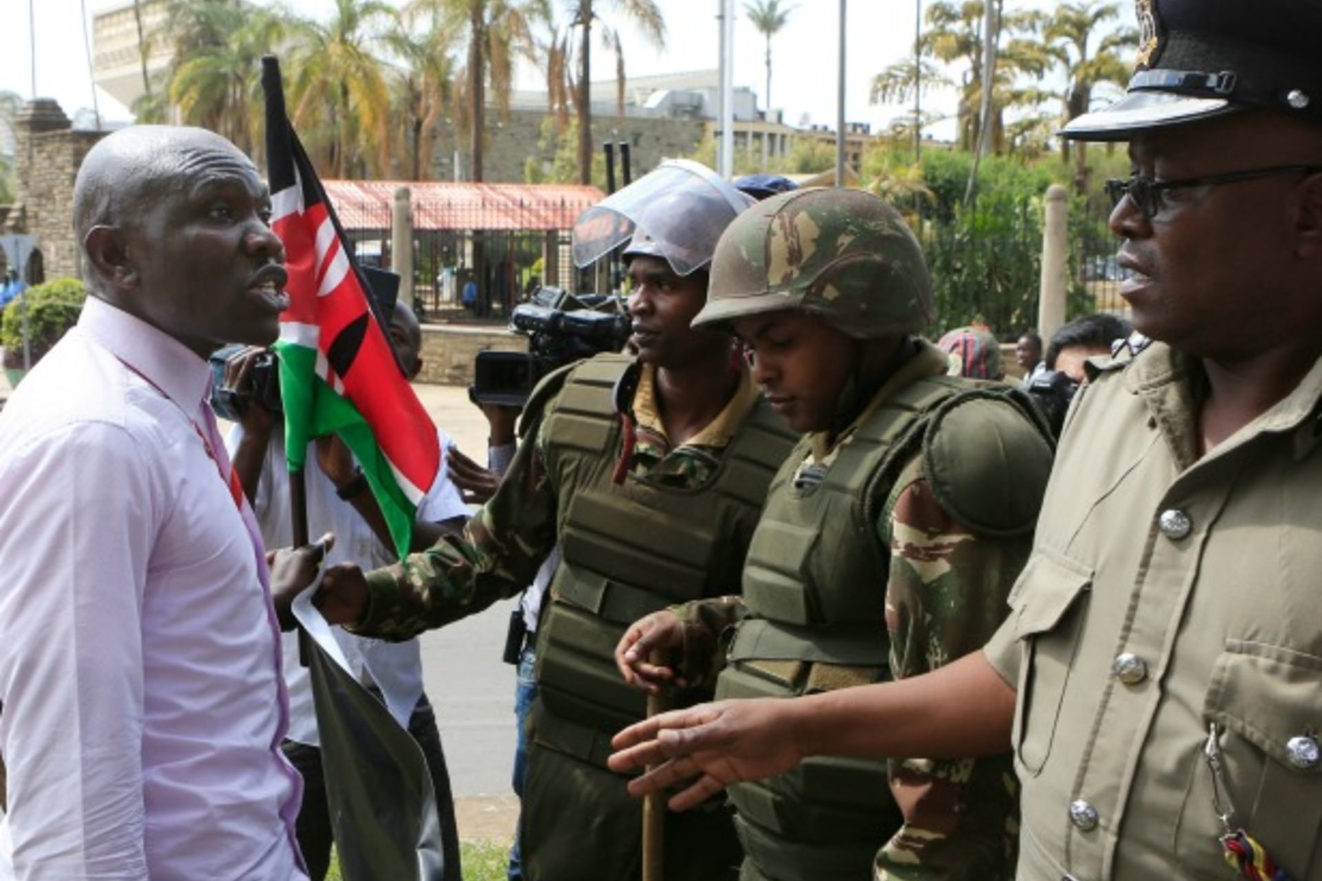 <p>Police stop a protester from demonstrating for freedom of speech outside Kenya’s parliament, December 18, 2014. (Courtesy REUTERS/Noor Khamis)</p>
