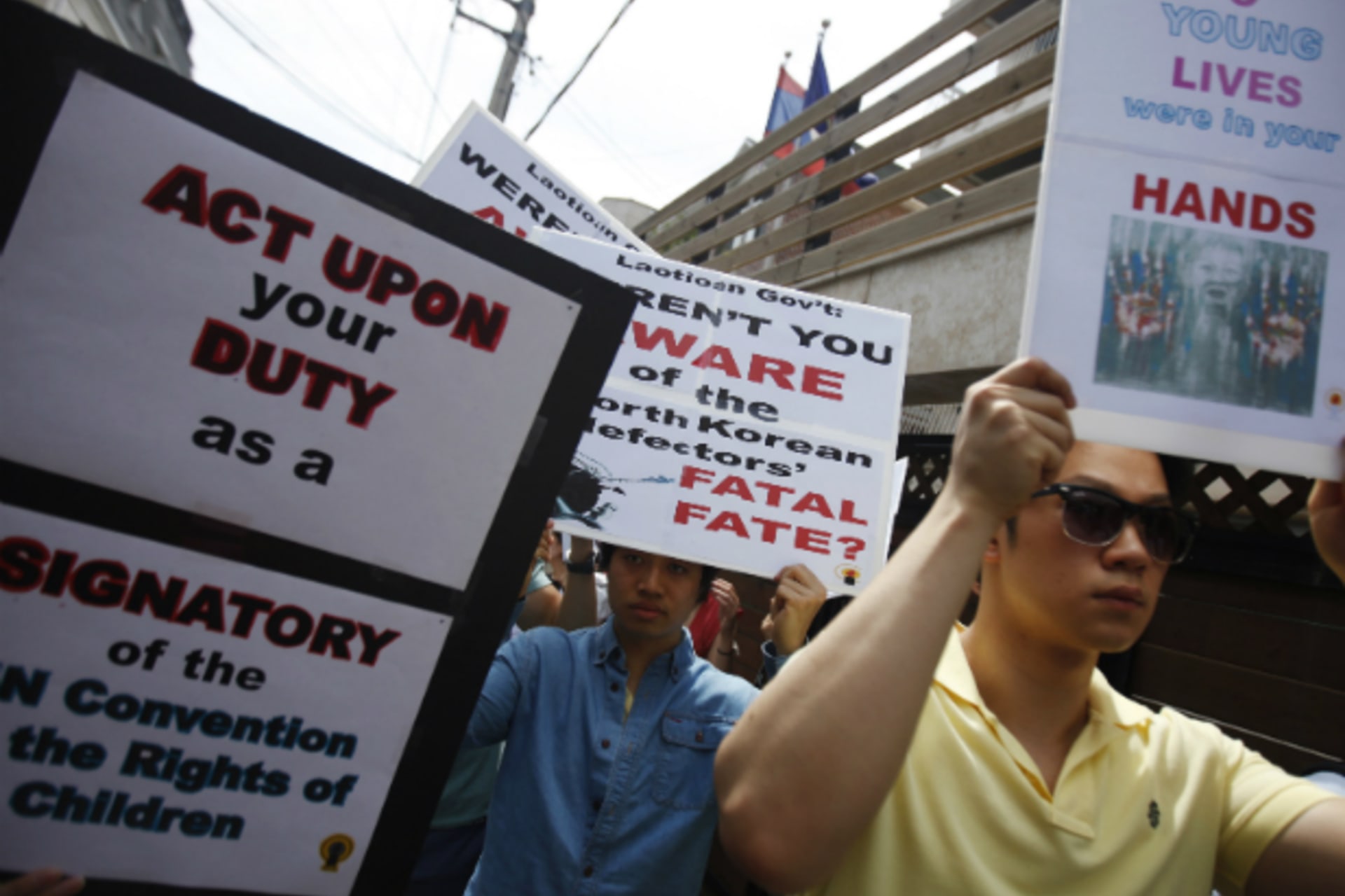 <p>Protesters from a human rights group hold signs during a rally against Laos’ recent repatriation of nine North Korean defectors, in front of the Laotian embassy in Seoul on May 31, 2013. (Kim Hong-Ji/Courtesy Reuters)</p>
