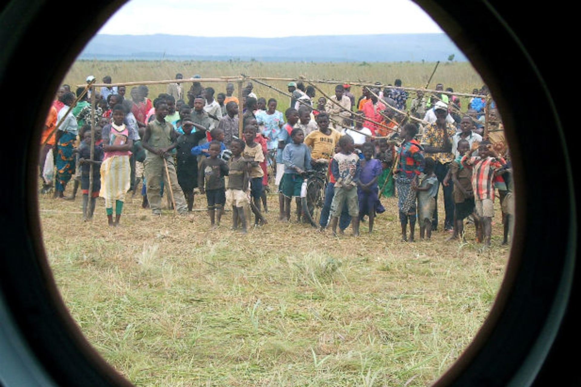 Congolese children in Mitwaba camp for internally displaced people watch as a U.N. helicopter lifts off after delivering emergency food aid in Katanga Province, eastern Democratic Republic of Congo February 9, 2006.