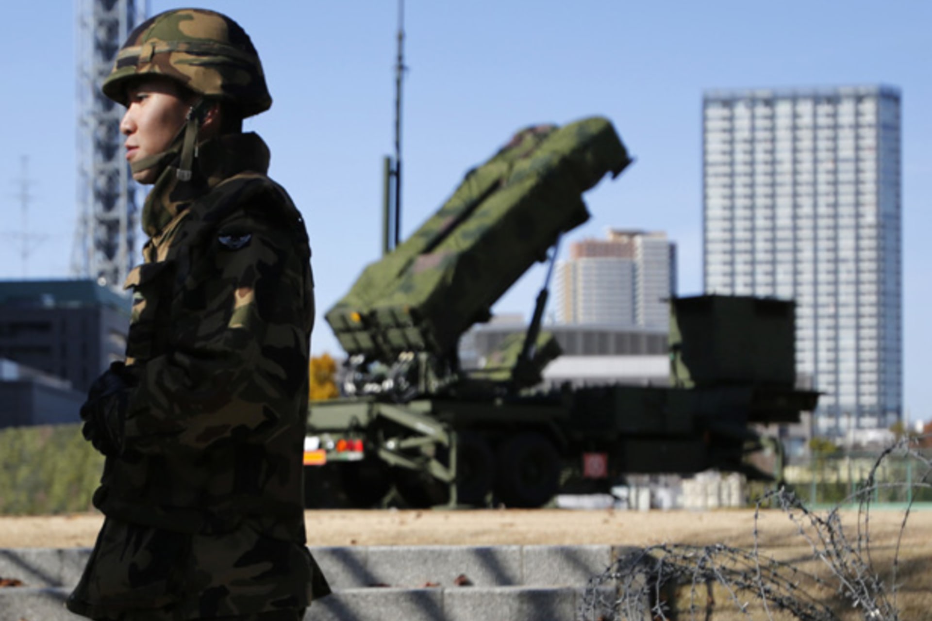 <p>Members of the Japan Self-Defence Forces stand guard near Patriot Advanced Capability-3 (PAC-3) land-to-air missiles, deployed at the Defense Ministry in Tokyo December 7, 2012</p>
