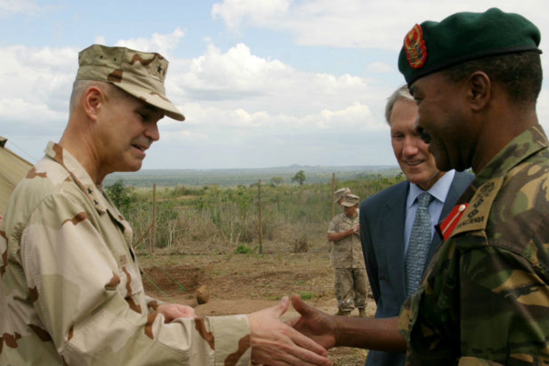 The Commander of Combined Joint Task Force-Horn of Africa Real Admiral Richard Hunt (L) meets Tanzania Peoples Defence Forces (TPDF), Director of Training, Col. Charles Jitenga (R) during the opening Msata dispensary in Bagamoyo, 120km (75 mile