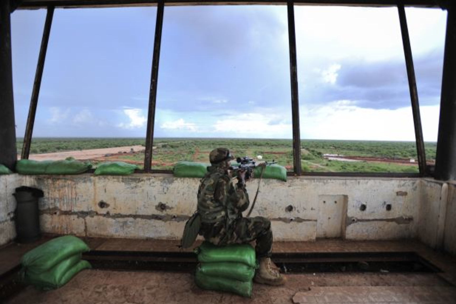 <p>A sniper in a control tower checks surrounding areas for al-Shabaab militants (Handout/Courtesy Reuters).</p>