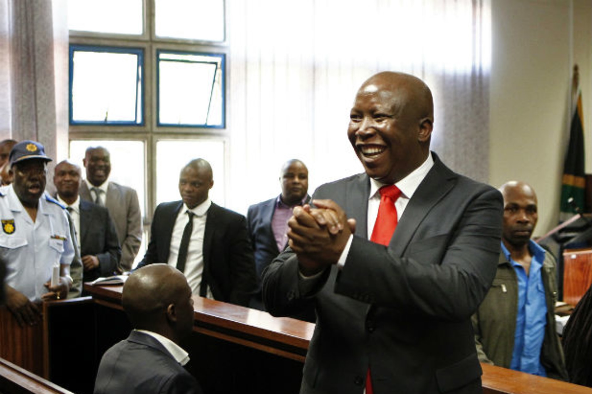 South African former ANC Youth League leader Julius Malema gestures to his supporters during his court appearance in Polokwane 26/09/2012.