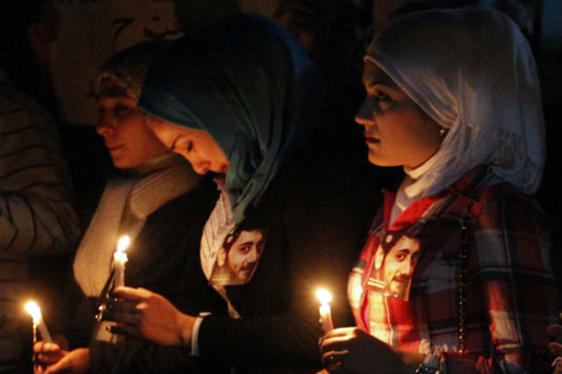 Women hold candles as they mourn at a funeral earlier this week in Raqqa province east of Syria May 16, 2013 (Kelze/Courtesy Reuters).