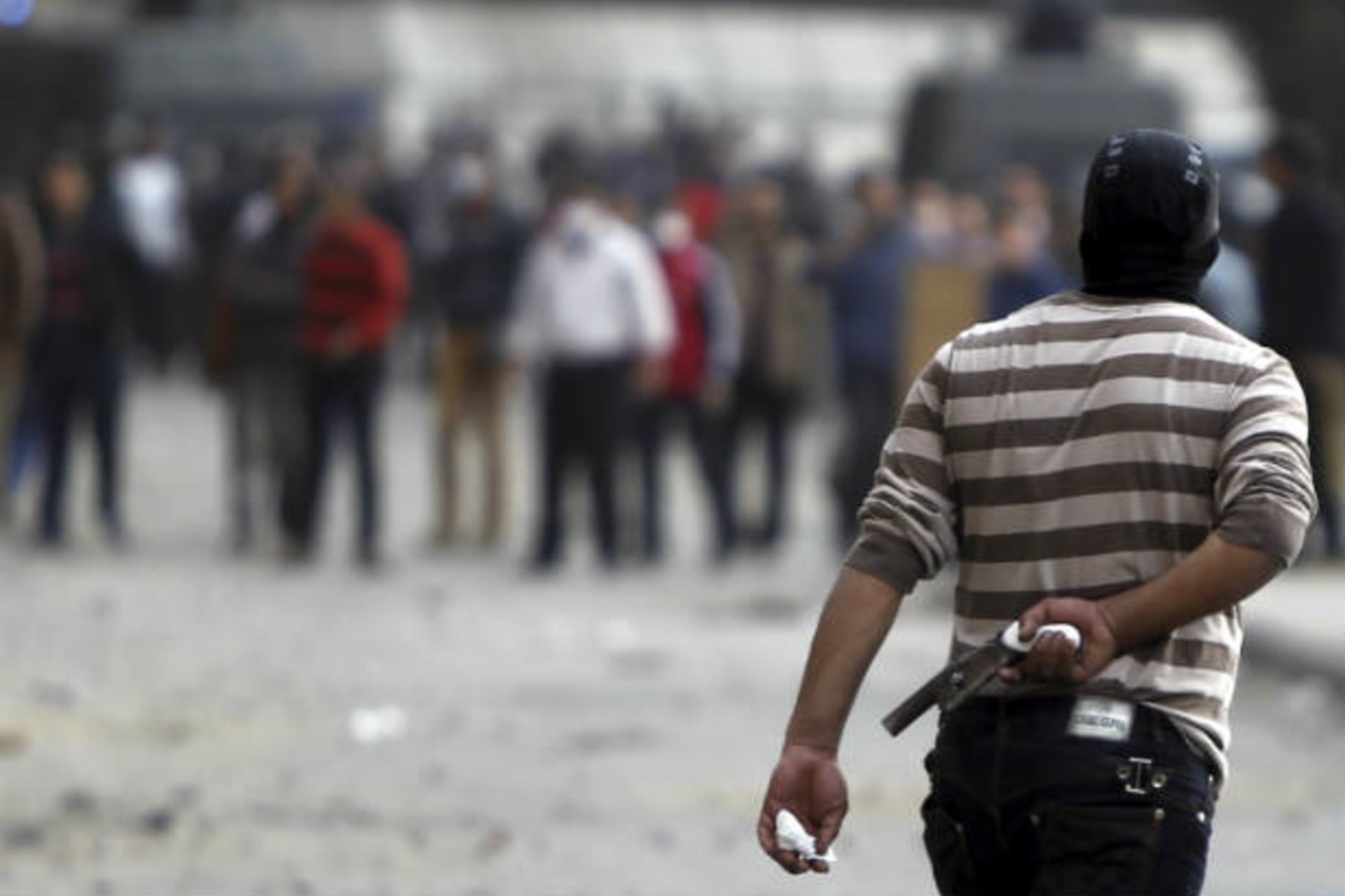 A protester opposing Egyptian president Mohammed Morsi holds a homemade gun during clashes with riot police, along Qasr Al Nil bridge in Cairo on January 27, 2013 (Dalsh/Courtesy Reuters).