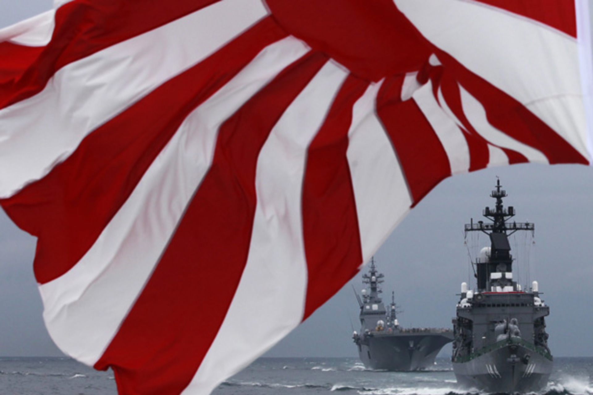 <p>Japanese Maritime Self-Defense Force (MSDF) destroyer Kurama (R) leads destroyer Hyuga as a Japanese naval flag flutters during a naval fleet review at Sagami Bay, off Yokosuka, south of Tokyo October 14, 2012</p>
