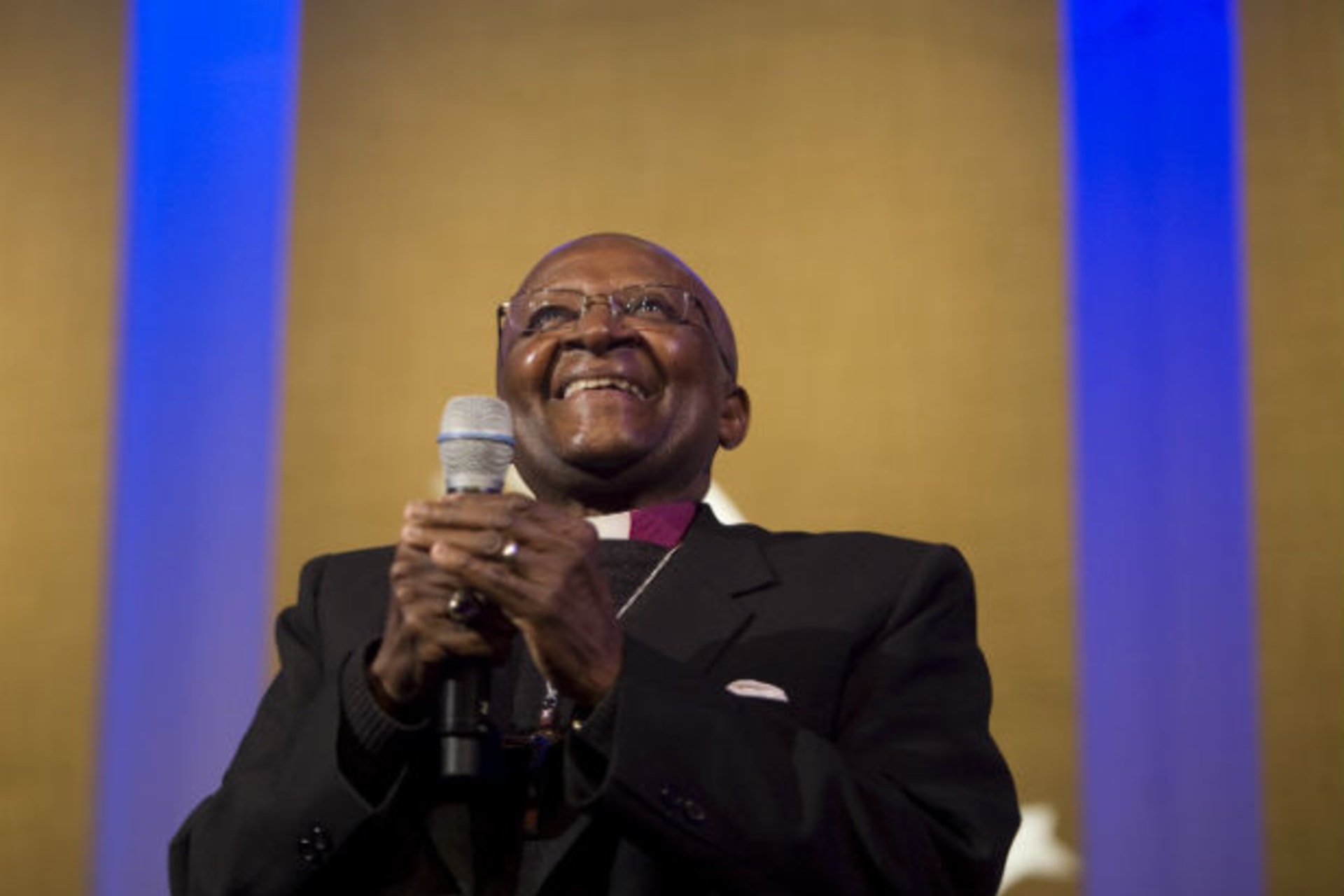 Archbishop Desmond Tutu, Chairman of The Elders, listens to Aung San Suu Kyi, General Secretary of the National League for Democracy who was speaking over a monitor from Myanmar, during a discussion regarding humanitarian leadership at the Clin