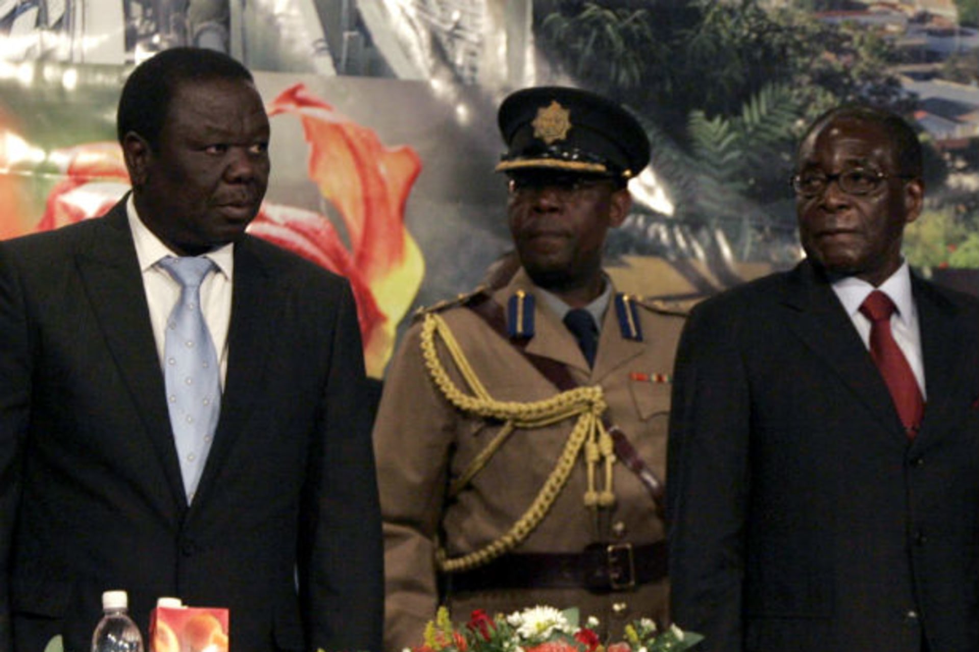 Zimbabwe's President Robert Mugabe (R) and Prime Minister Morgan Tsvangirai (L) attend the Zimbabwe international investment conference in Harare July 9, 2009.