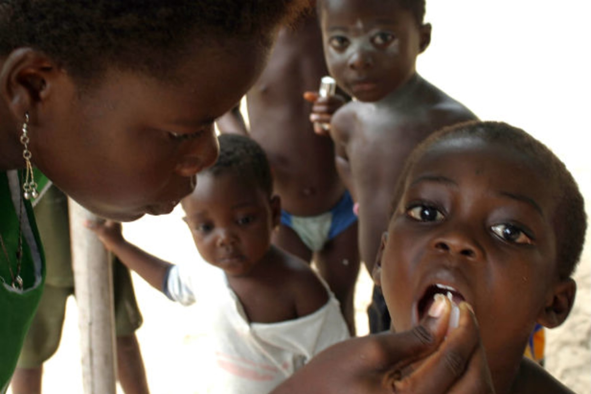 Ilashe, Nigeria. A health worker immunises a four-year-old boy at Ilashe island, 25 km (15 miles) from the Nigerian capital Lagos, May 16, 2005. Nigeria has launched the third round of the National Immunization Campaigns this year in hopes of e