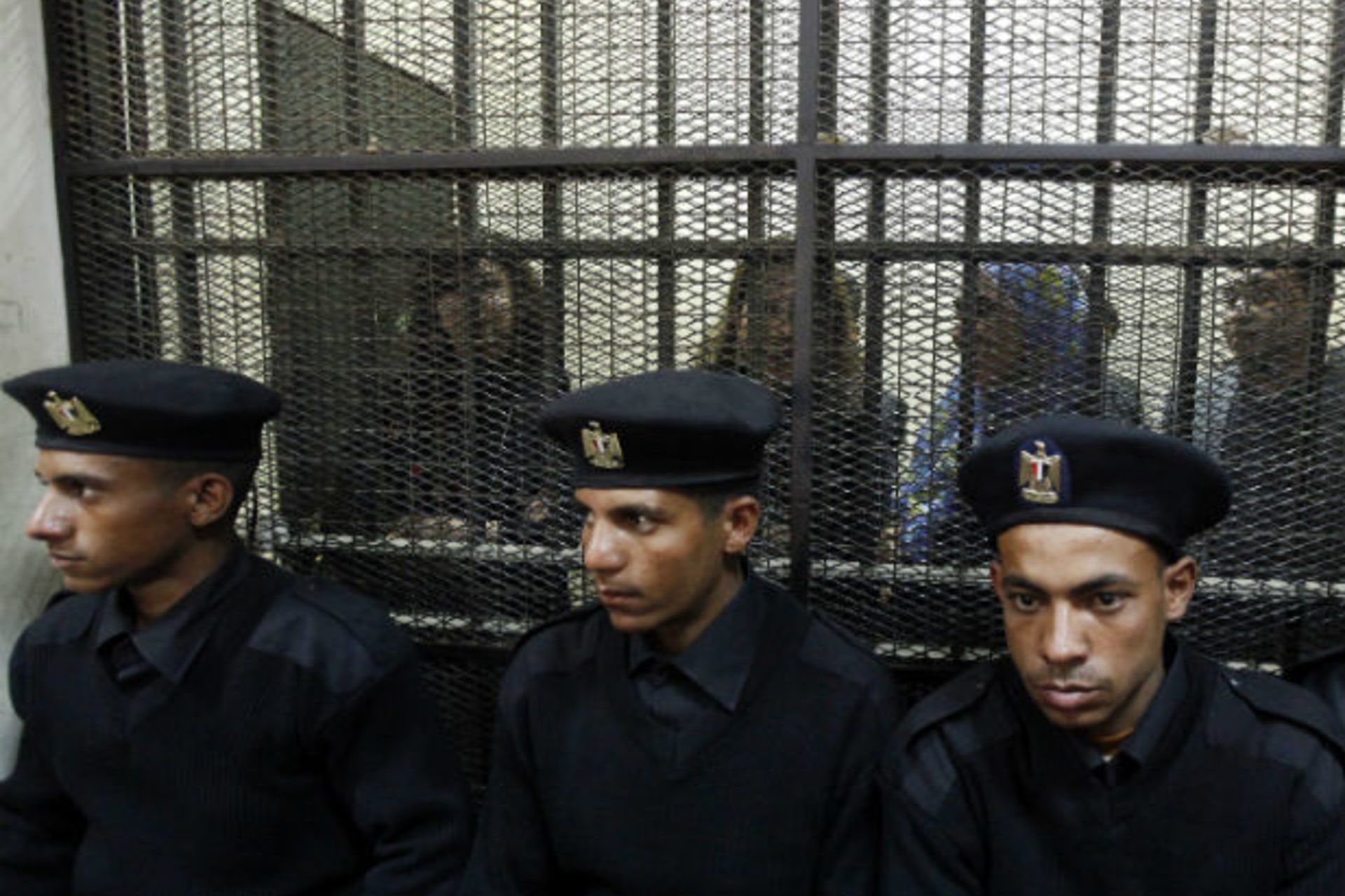 <p>Egyptian activists accused of working for outlawed non-governmental organizations stand trial in Cairo in February 2014.</p>