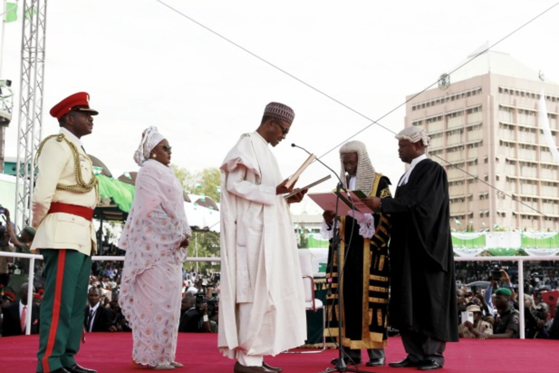 <p>Chief Justice of Nigeria Mahmud Mohammed swears in Muhammadu Buhari (C) as Nigeria’s president while Buhari’s wife Aisha looks on at Eagle Square in Abuja, Nigeria May 29, 2015. (Afolabi Sotunde/Reuters)</p>
