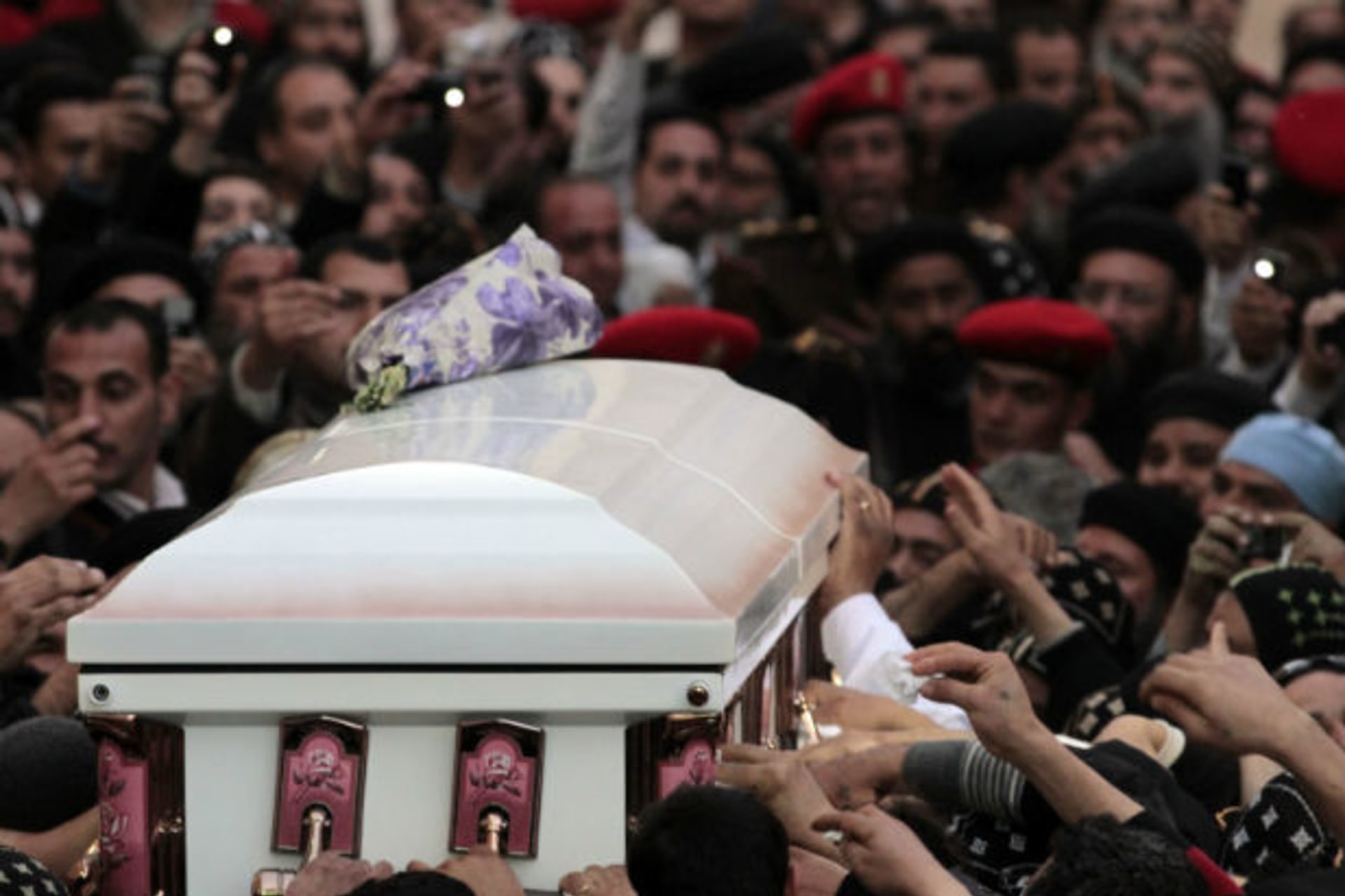 Egyptian Coptic priests and Christians carry the coffin of Pope Shenouda III, the head of Egypt's Coptic Orthodox Church, upon its arrival for burial at St. Bishoy Monastery in Wadi al-Natrun, on March 20, 2012 (Mohamed Abd El Ghany/Courtesy Re