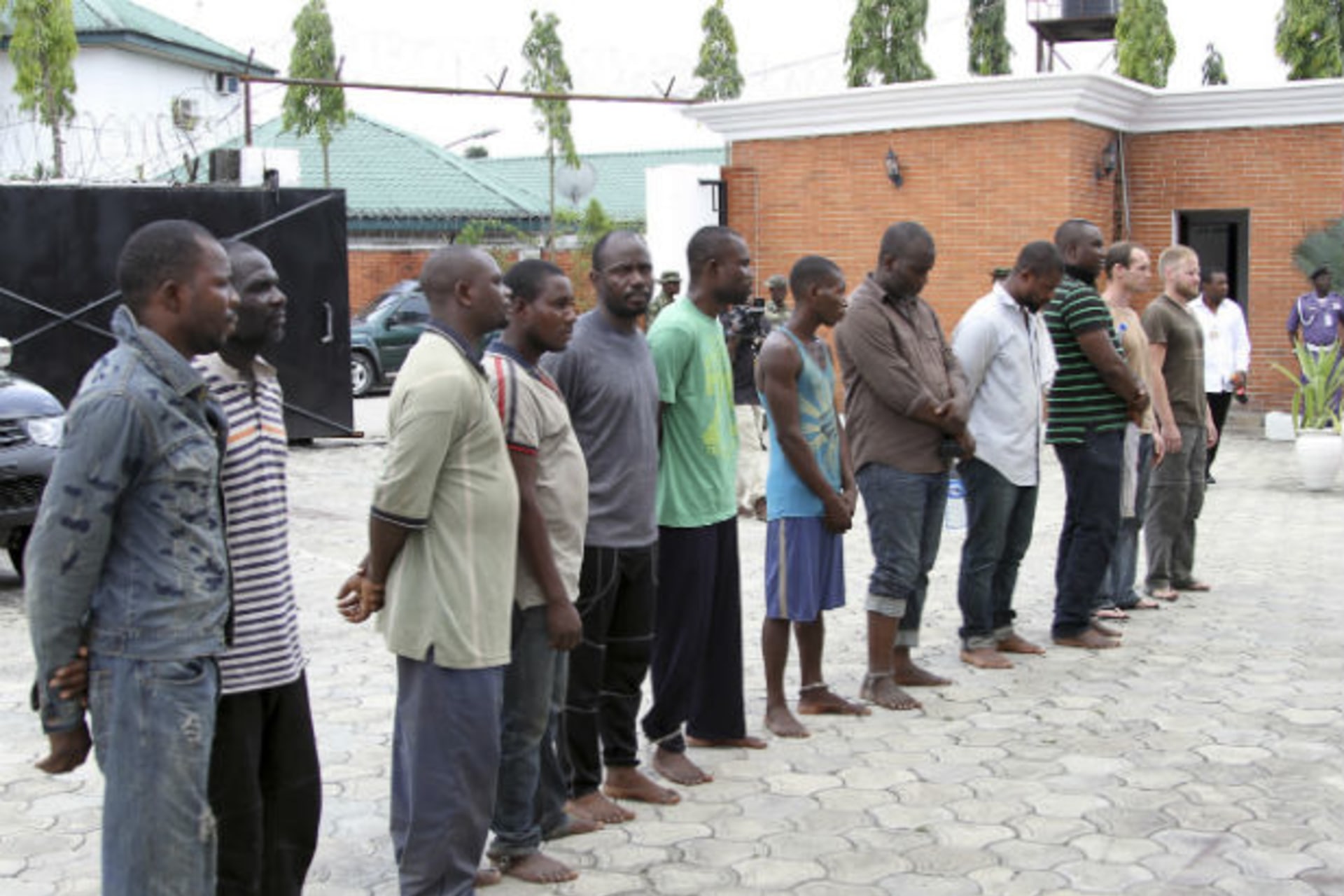 Men suspected to be involved in oil theft are paraded to the media at a military base in Yenagoa, March 28, 2014. (Stringer/Courtesy Reuters)