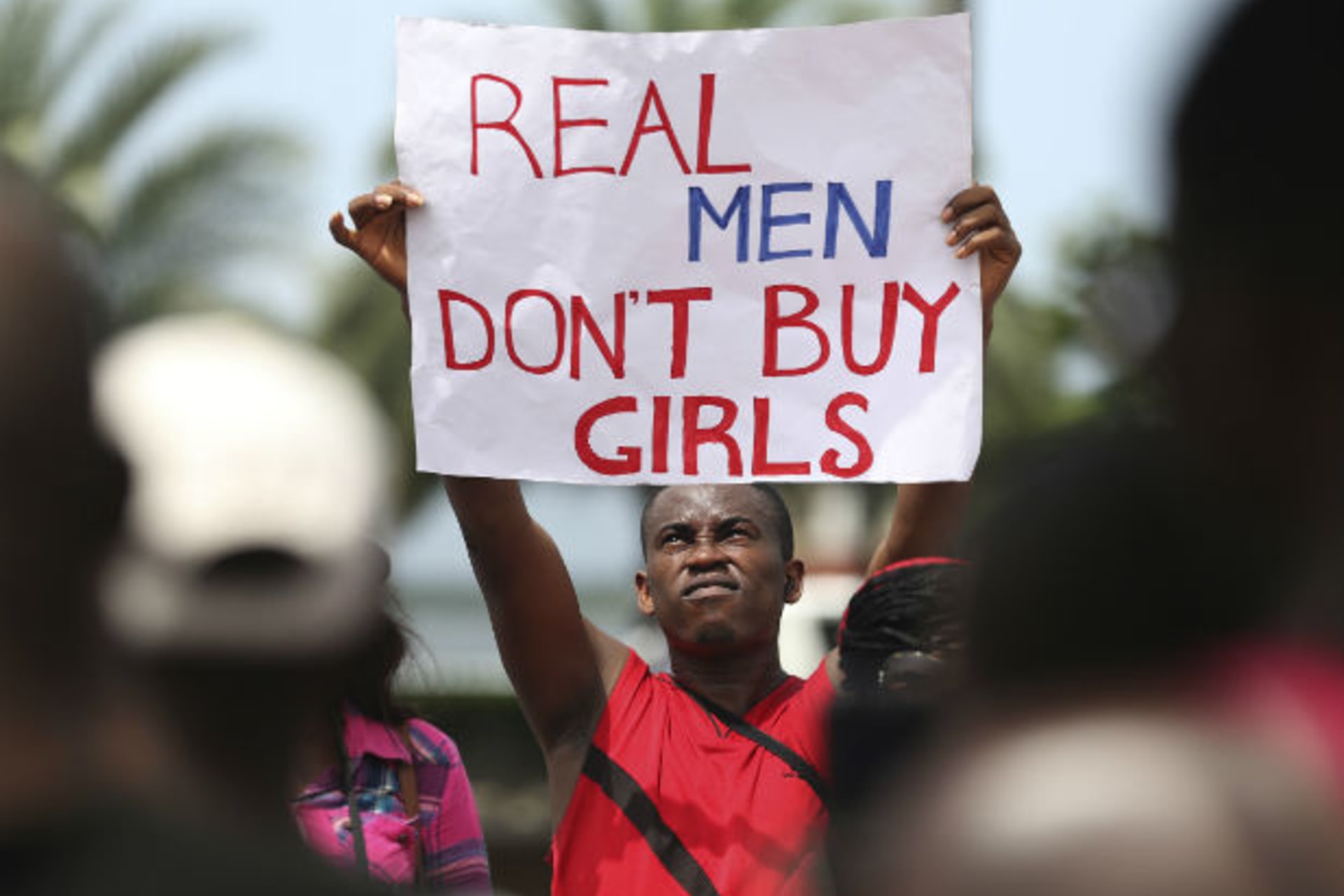 A man holds a placard as youths protest the release of abducted school girls in the remote village of Chibok, in Lagos May 10, 2014.