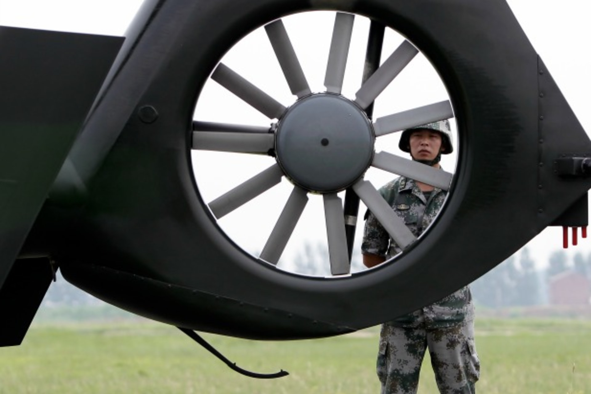 <p>A soldier stands guard next to a Z-9WZ military helicopter designed and manufactured by China during a media visit at the mili…ion Army (PLA) Army Aviation 4th Helicopter Regiment, on the outskirts of Beijing, July 24, 2012. (Jason Lee/Courtesy Reuters)</p>
