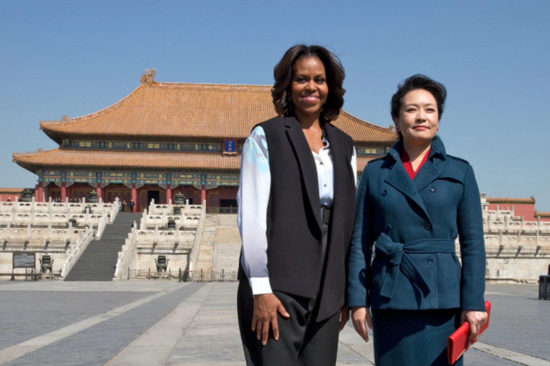 U.S. first lady Michelle Obama and Peng Liyuan, wife of Chinese President Xi Jinping, pose for a photograph as they visit Forbidden City in Beijing on March 21, 2014.