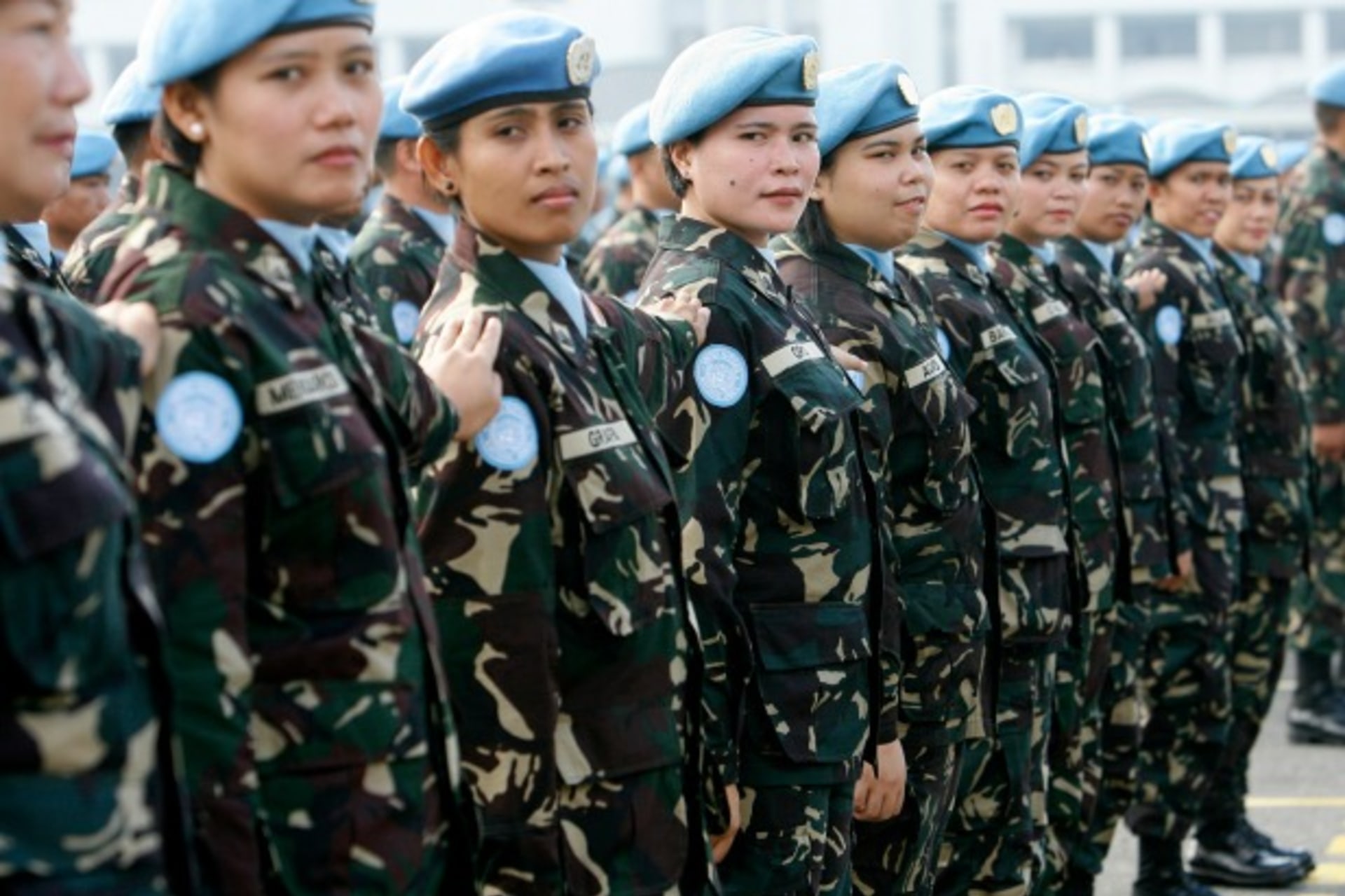 <p>Female members of a Philippine peacekeeping force bound for Liberia stand at attention during a send-off ceremony at the military headquarters in Manila, January 2009 (Romeo Ranoco/Reuters).</p>

