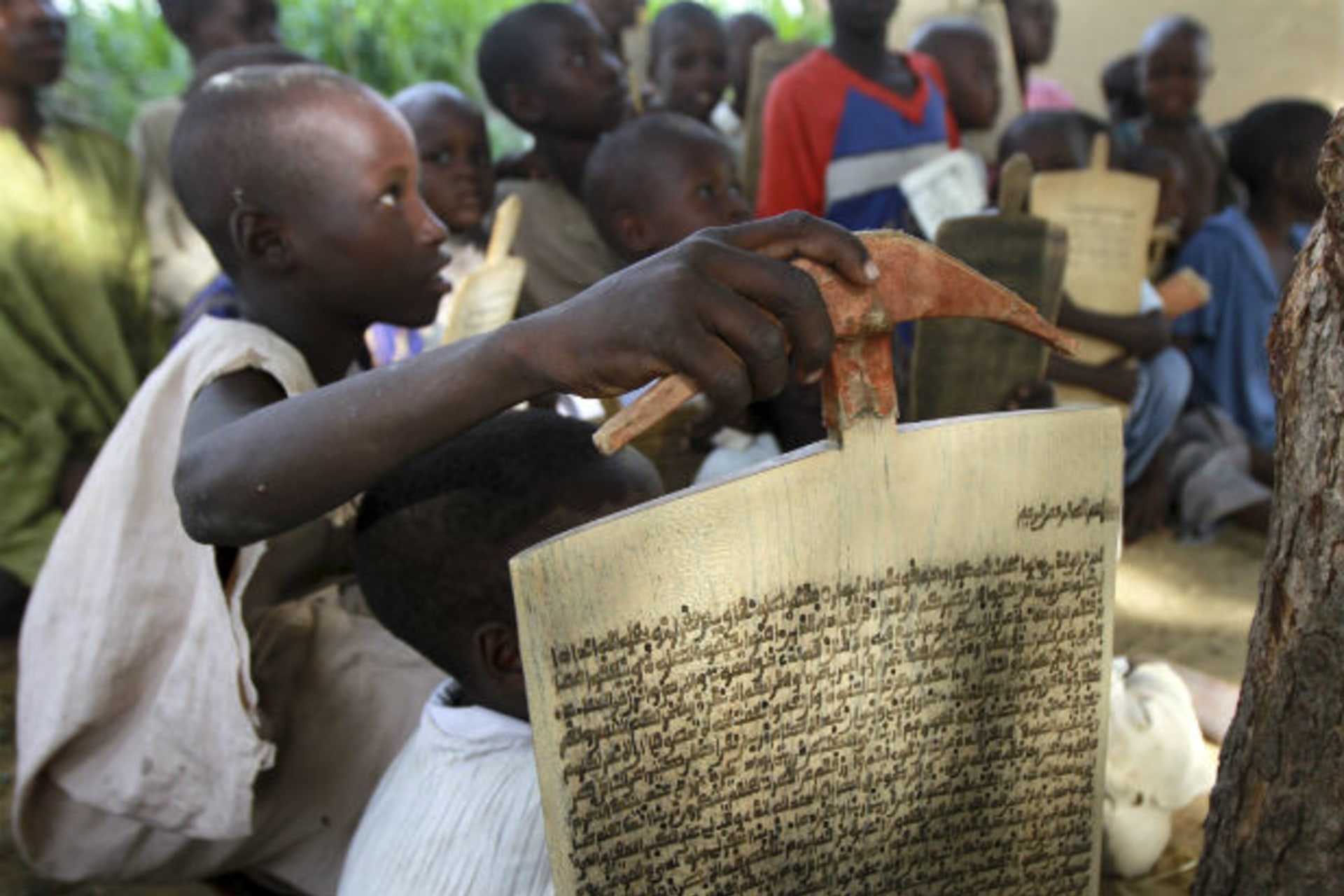 Children recite verses from the Koran outside a Koranic school in Bichi village, on the outskirt of Nigeria's northern city of Kano July 25, 2012.