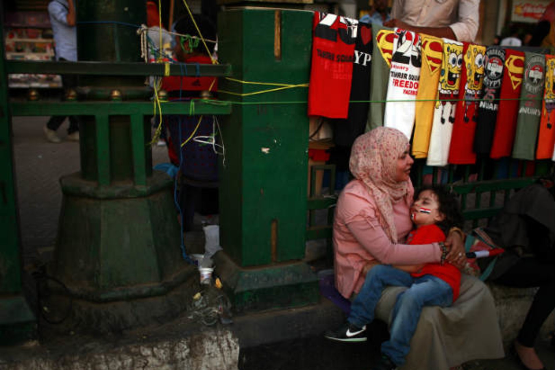 An Egyptian woman holds her son during a demonstration at Tahrir square in Cairo (Salem/Courtesy Reuters).