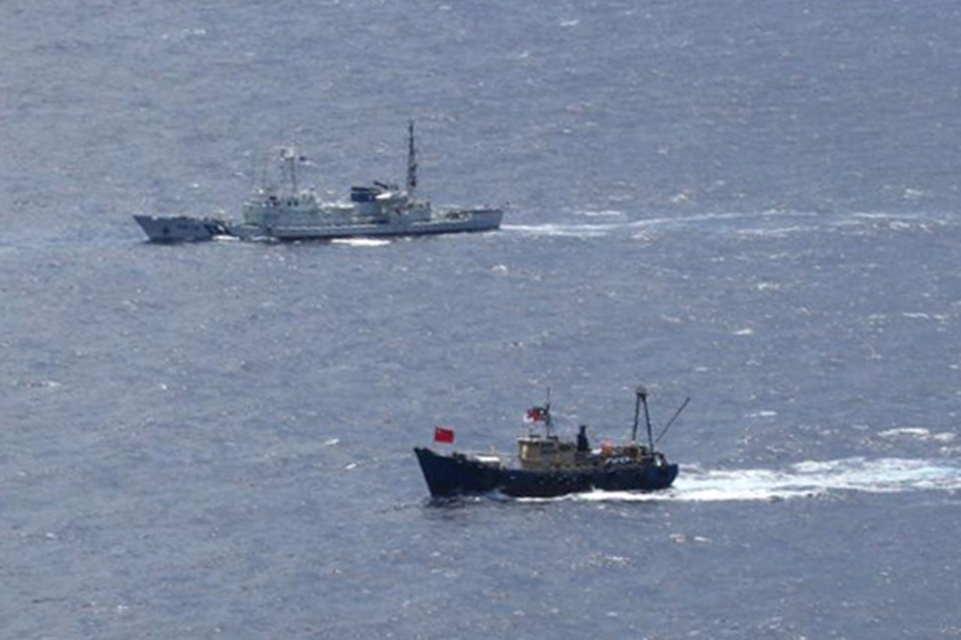 <p>A Japan Coast Guard patrol ship sails around a Hong Kong fishing boat near the disputed islands in the East China Sea, known as Senkaku in Japan or Diaoyu in China</p>

