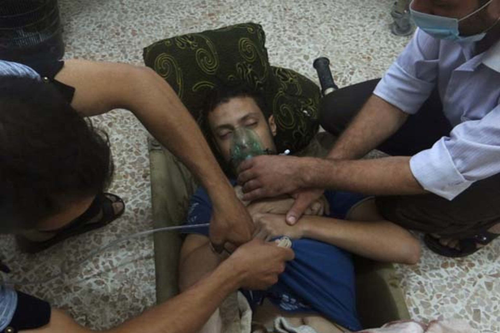 A man, affected by what activists say is nerve gas, breathes through an oxygen mask in the Damascus suburbs of Jesreen