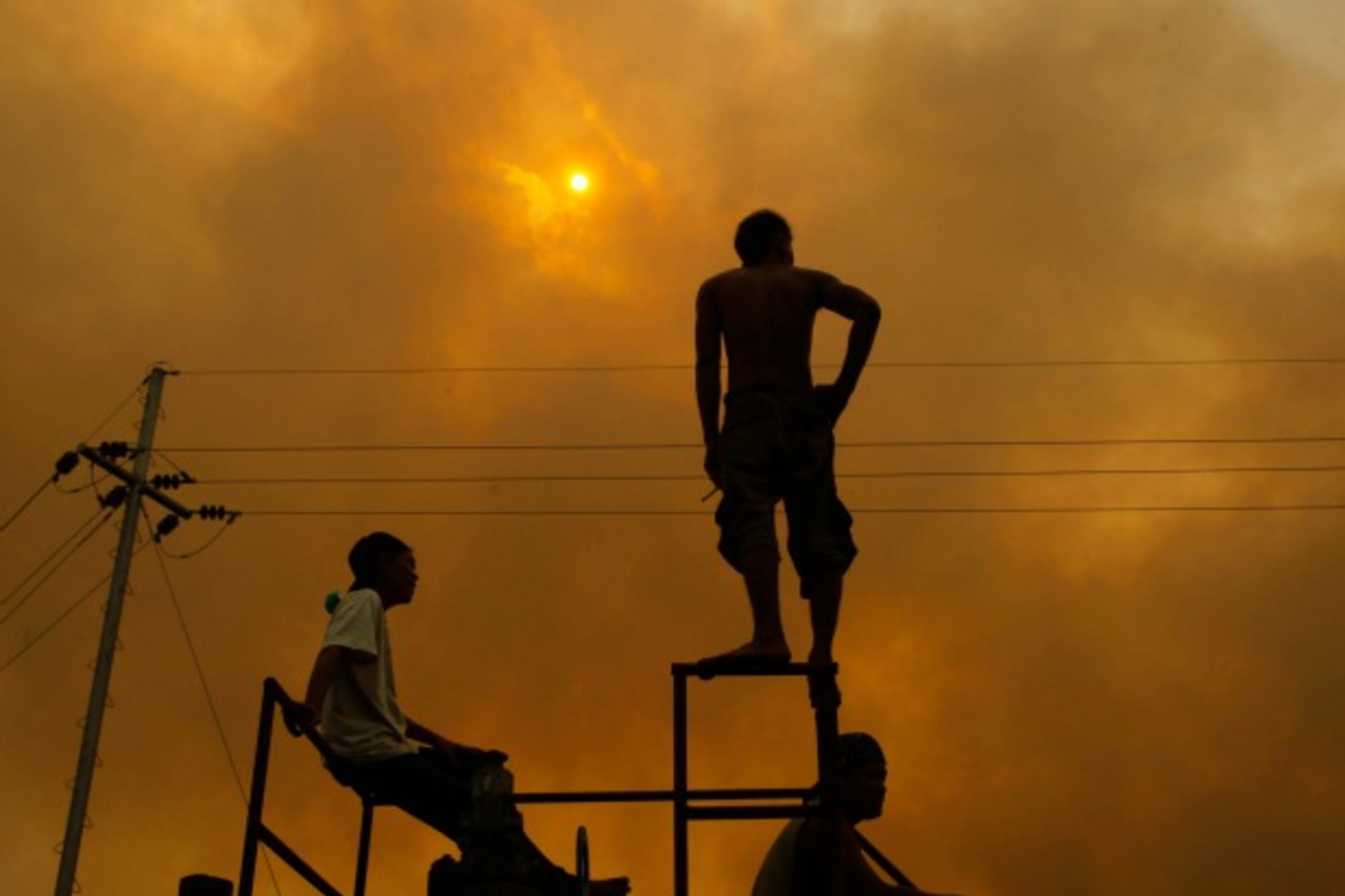 <p>A worker stands as he looks on at fire from burning trees planted for palm oil, during haze in Indonesia’s Riau province on June 24, 2013.</p>