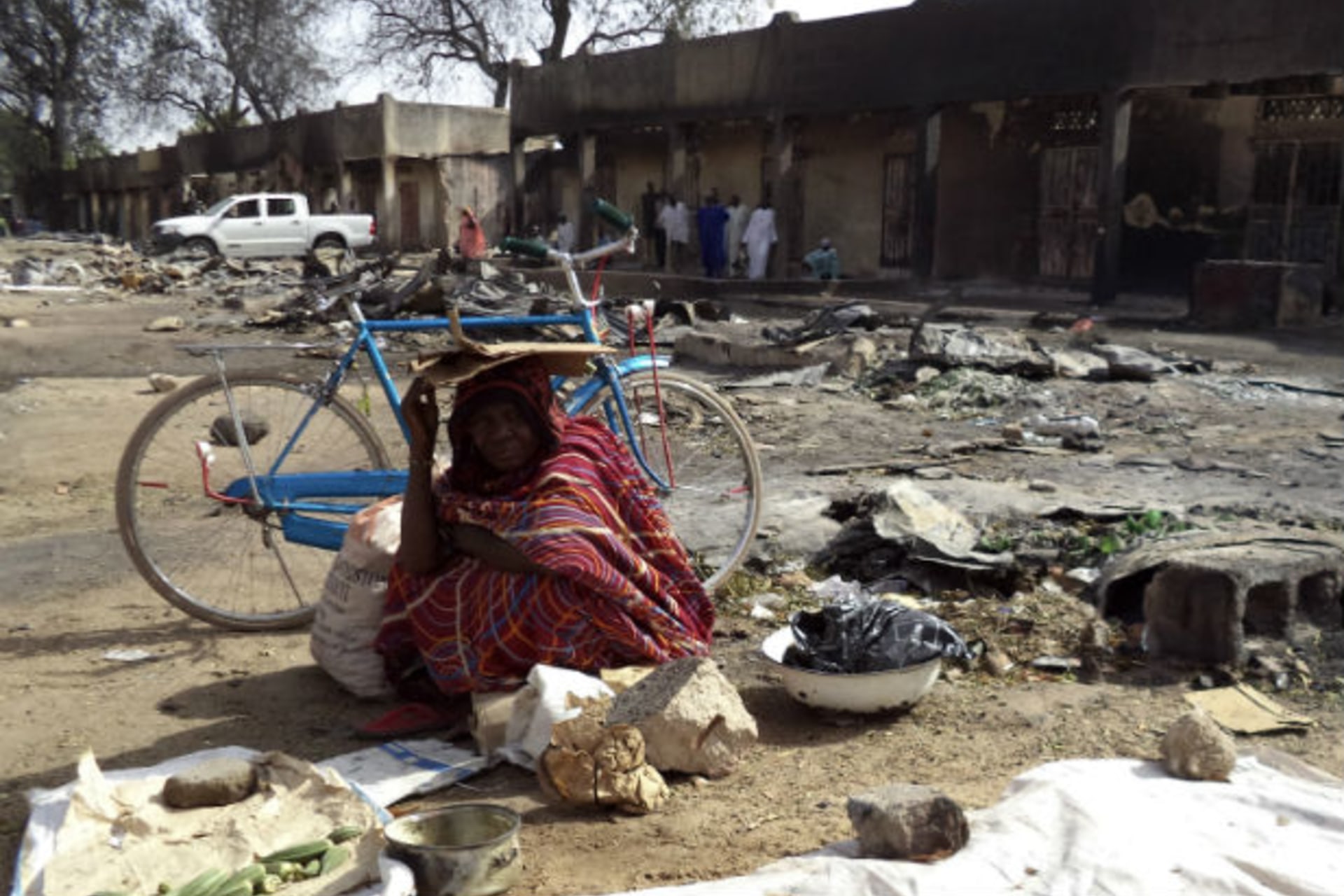 A woman sits amongst the ruins of the burnt Bama Market, which was destroyed by gunmen in last Thursday's attack, in Maiduguri, northeast Nigeria April 29, 2013.