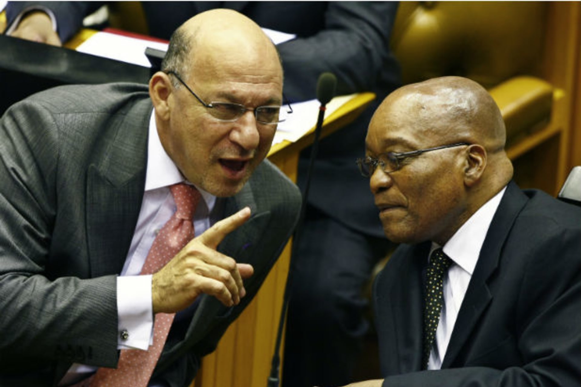 South Africa's Finance Minister Trevor Manuel chats with ruling African National Congress President Jacob Zuma in Parliament in Cape Town during the swearing in of members and the formal election of the country's president, May 6, 2009.