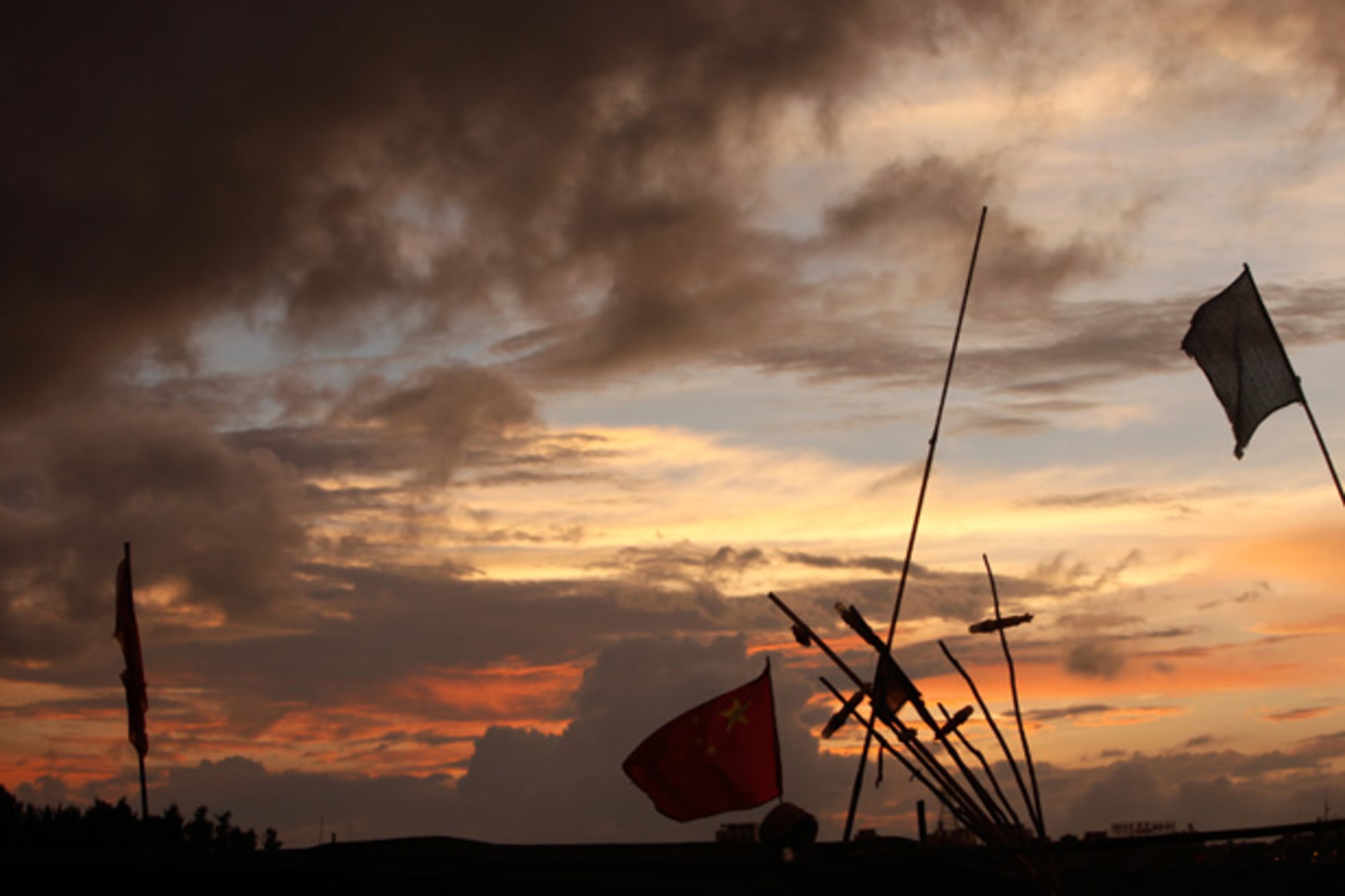 <p>A Chinese national flag is seen on a boat at a fishing village in Tanmen town, Hainan province, next to the South China Sea.</p>

