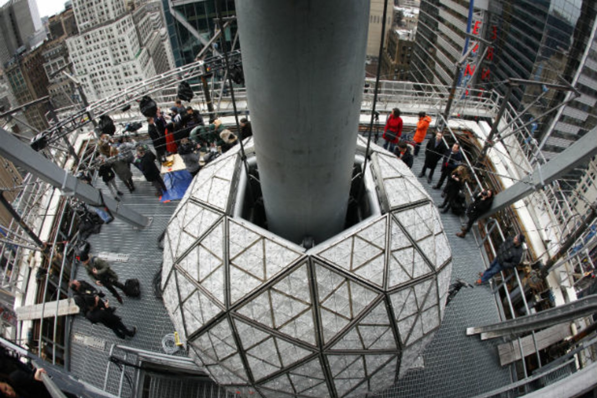 Journalists watch workers install some of the 288 Waterford crystals on the Times Square New Year's Eve Ball in New York (Mike Segar/Courtesy Reuters).