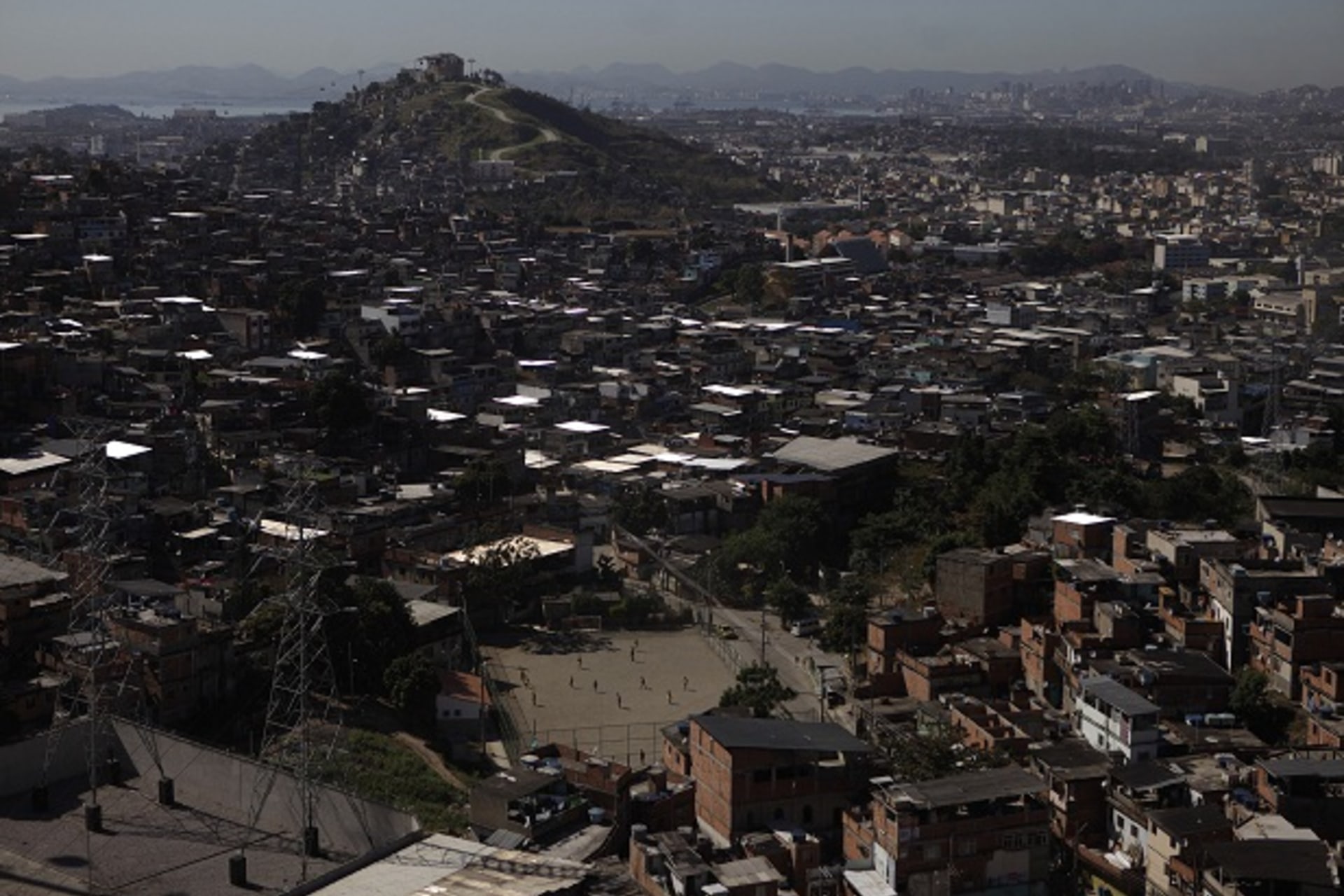 People play soccer in Complexo do Alemao slum in Rio de Janeiro