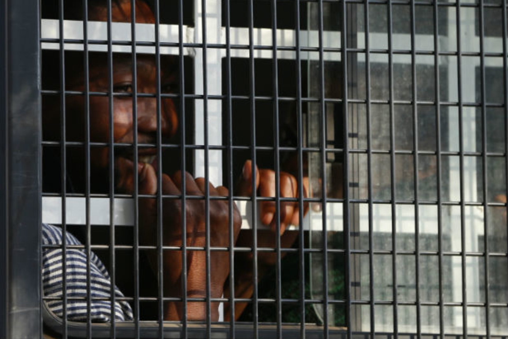 A detained miner peers out of a police van as it arrives at court in Ga Rankuwa, near Pretoria 03/09/2012