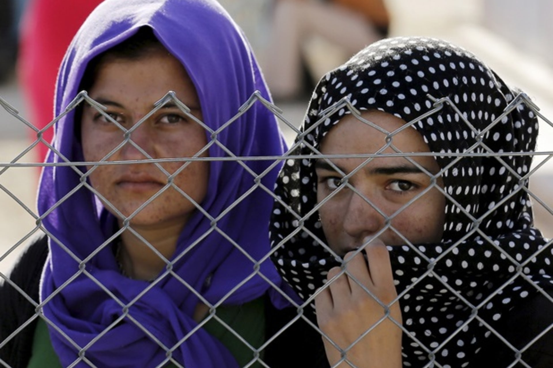 <p>Yazidi refugees stand behind fences as they wait for the arrival of United Nations High Commissioner for Refugees Special Envo… Syrian and Iraqi refugee camp in the southern Turkish town of Midyat in Mardin province, June 20, 2015 (Umit Bektas/Reuters).</p>