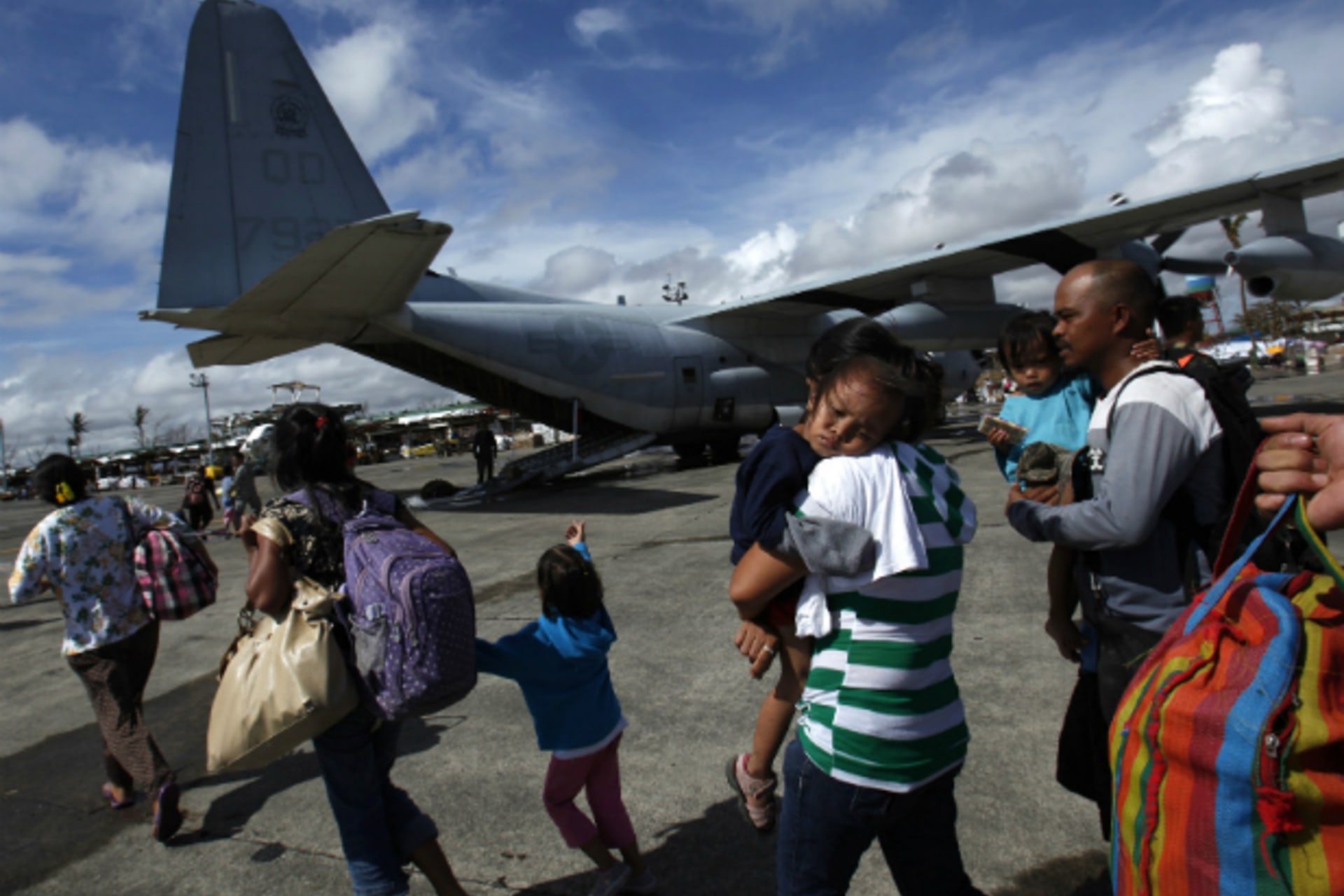 <p>Evacuated residents prepare to get onto a U.S. military plane at Tacloban airport in central Philippines on November 13, 2013, five days after Typhoon Haiyan devastated the area. (Bobby Yip/Courtesy Reuters)</p>
