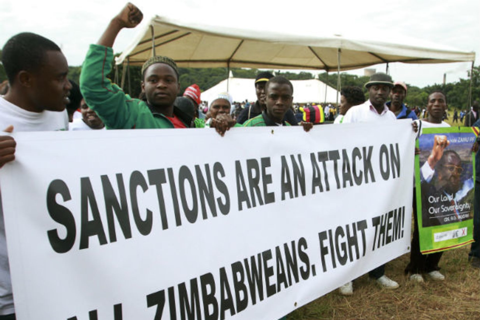 Crowds cheer Zimbabwe's President Robert Mugabe during a rally in the capital Harare March 2, 2011.