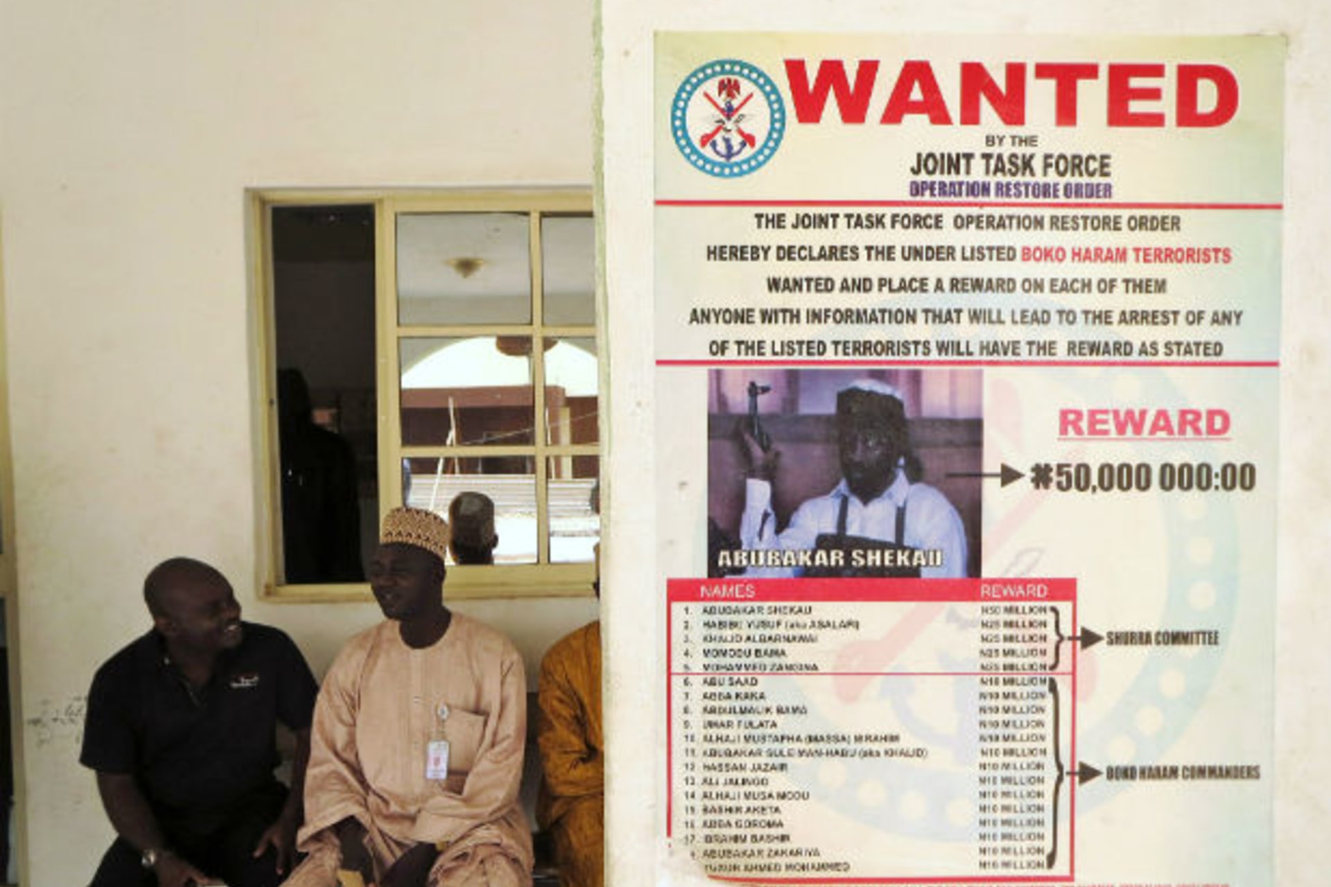 A poster advertising for the search of Boko Haram leader Abubakar Shekau is pasted on a wall in Baga village on the outskirts of Maiduguri, in the north-eastern state of Borno May 13, 2013.
